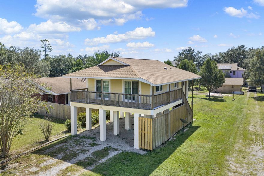 There's a lot of NEW here for you! New flooring throughout, new HVAC, and a new front door. Windows and sliding doors were replaced 2 years ago; roof and water heater are 3 years old. Move in and start enjoying your new home! Built on pilings, it offers a spacious deck for morning coffee and covered parking below for cars, a boat, or an RV. The large lot has room for a shop, patio, or firepit--so much potential! Walk to the Oriole Beach Boat Ramp and park your trailer at home. Conveniently located near schools, 10 minutes to Gulf Breeze, 14 minutes to Pensacola Beach, 22 minutes to downtown, and 34 minutes to NAS Pensacola. Open House Sat, Oct 11 | 11:00-2:00.  Stop by and say hello!