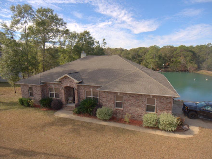 CUSTOM BUILT HOME ON BEAUTIFUL PRIVATE LAKE. This home gives you the feel of living in the country but is just minutes from town center. Kitchen, Bathroom and Utility/Laundry room have travertine floors. Kitchen has granite counter tops with a large walk in pantry. Master bedroom is very spacious with access to the large covered porch. Master bathroom has a large walk in closet, water closet for privacy, whirlpool tub, separate shower with facing His and Hers shower heads. All bedrooms are carpeted with wood flooring throughout the remaining living spaces. Raised ceilings throughout the entire home with trayed ceilings in Master Bedroom, Living Room and Dining Room. Wide crown molding in every room. You will love spending time in the living room relaxing next to the wood burning fireplace