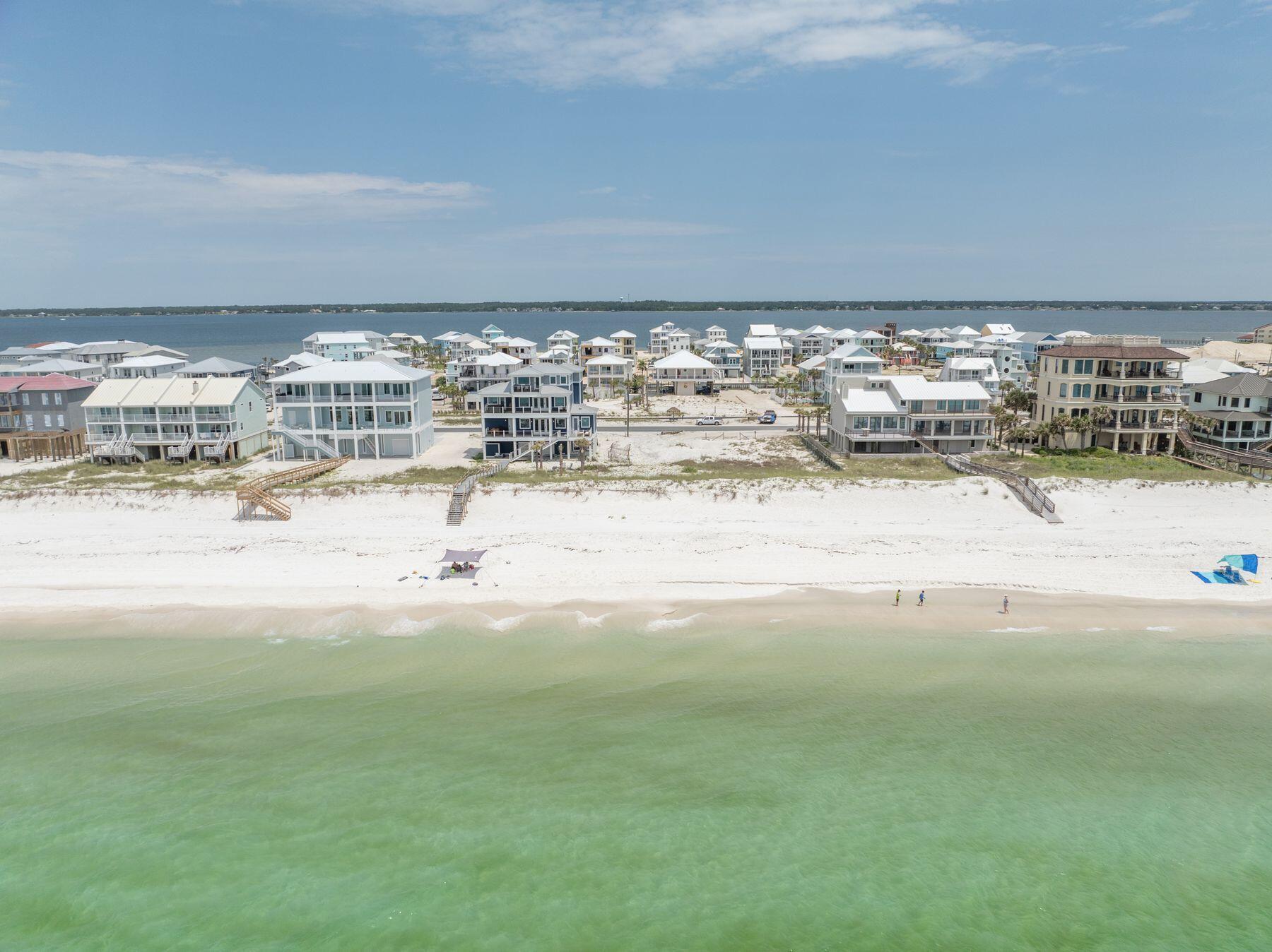 Imagine waking up each morning to the breathtaking views of the Gulf of Mexico and the serene bay, right from your doorstep. This unique opportunity allows you to build your dream home directly on the pristine sands of Navarre Beach, often called ''Florida's Best Kept Secret.'' Lot 6 boasts 95 feet of gulf frontage and a depth of approximately 133 feet, totaling more than one quarter of an acre of prime beachfront property. Nestled in a peaceful and private residential neighborhood, this gulf-front lot offers the perfect blend of tranquility and opportunity. With no HOA fees, you'll enjoy the freedom to create a custom home tailored to your desires, whether it be a full-time residence or a lucrative vacation rental. The location is a water enthusiast's paradise, offering a private-style.... beach with emerald green waters and easy access to the bay, ideal for boating and water sports. The famous Navarre Pier, the longest in Florida, is just a short walk or bike ride away, providing excellent fishing opportunities, stunning sunsets and an outdoor restaurant for dining with a view. Nature lovers will appreciate the proximity to the Santa Rosa area of the Gulf Islands National Seashore and the nearby state park, perfect for hiking, bird watching, exploring historic forts and camping. The lot is ready for development, with all required zoning, environmental tests, and permits from the county and the Department of Environmental Protection (DEP) completed by the sellers. The only step remaining is the approval of architectural/building permits, with existing building plans for a single-family dwelling available for interested buyers. Seize this rare chance to own a piece of paradise on Navarre Beach, where you can enjoy the best of Florida living.