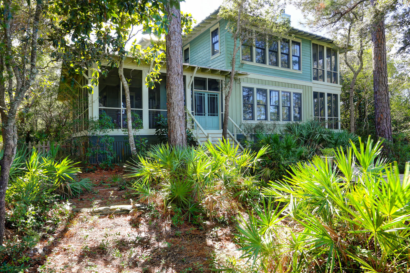 Built with care to blend with the natural wooded surroundings, this lovely home is nestled among the native vegetation of the Emerald Coast. Secluded and serene in Point Washington, it is just minutes to the beach and all Scenic 30 A has to offer. There are amazing bay views with 179 feet of deep water bayou frontage and immediate access to the bay. A 180' pier leads to deep water McQuage Bayou with room for a boat lift and access to the community bay front beach and pier. Every intention of the design of this home is to complement its surroundings. Bay views are astounding from both stories. Exterior features of this home are 1,043 SF of 3 covered and screened porches, cedar exterior siding - lap, shake and board & batten patterns - with a standing seam metal roof. A long entry porch