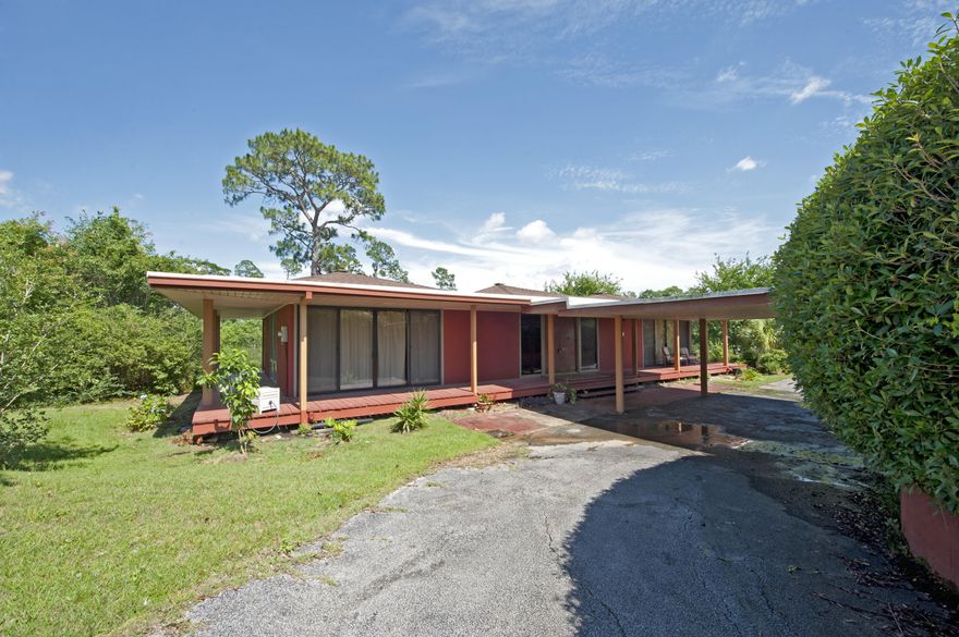 Back on the Market! Your perfect golf retreat awaits. This home is the winner of architectural excellence from the American Institute of Architects, and features a unique and open design that you will fall in love with. Your new home sits just below the street level and is beautifully landscaped to give you that perfect amount of privacy. This house is positioned just behind the 13th green of the Scenic Hills golf course. You'll enjoy the atmosphere while on your deck that completely wraps around the house. Open your 6 sliding glass doors and enjoy a nice cool breeze throughout your home. New insulation under the house 2009, Roof 2014 with skylights, HVAC 2011. Don't miss out on this amazing home!