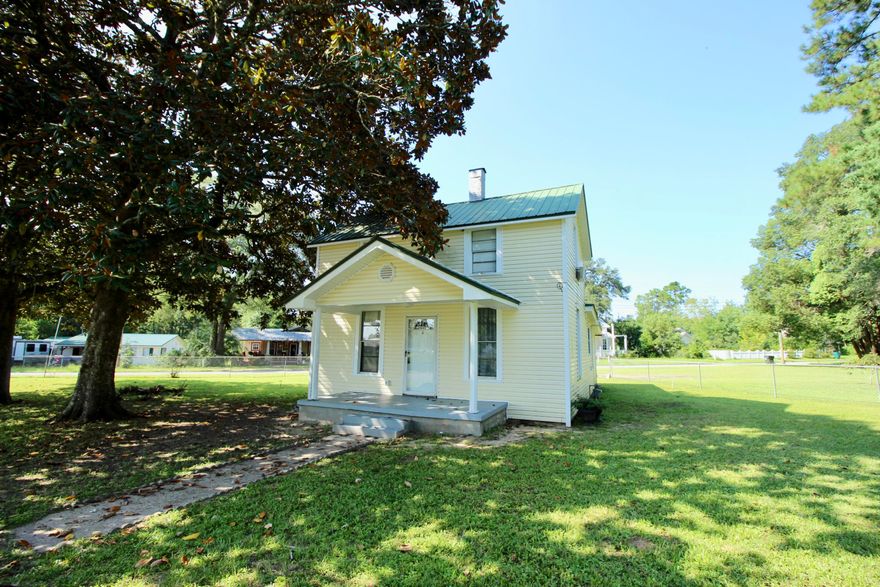 Quaint cottage in the heart of downtown DeFuniak Springs in the historic district, just a couple of short blocks to Lake DeFuniak. Two story vinyl siding home on large, corner 1/3 acre lot (lot lines go well beyond the fence). Beadboard ceiling in the dining and kitchen with large utility room leading to the fenced back yard. One downstairs bedroom and full bath with shower; then upstairs is the master bedroom with walk-in closet and sitting/landing area that could be used as a dressing area, office, etc. Just across from Walton Middle School and the lakeyard, the location can't be beat. Home is in good condition and has some updates - but also has room for you to put your personal touch on it. If you're looking to downsize or simplify your life, this may be your perfect chance!