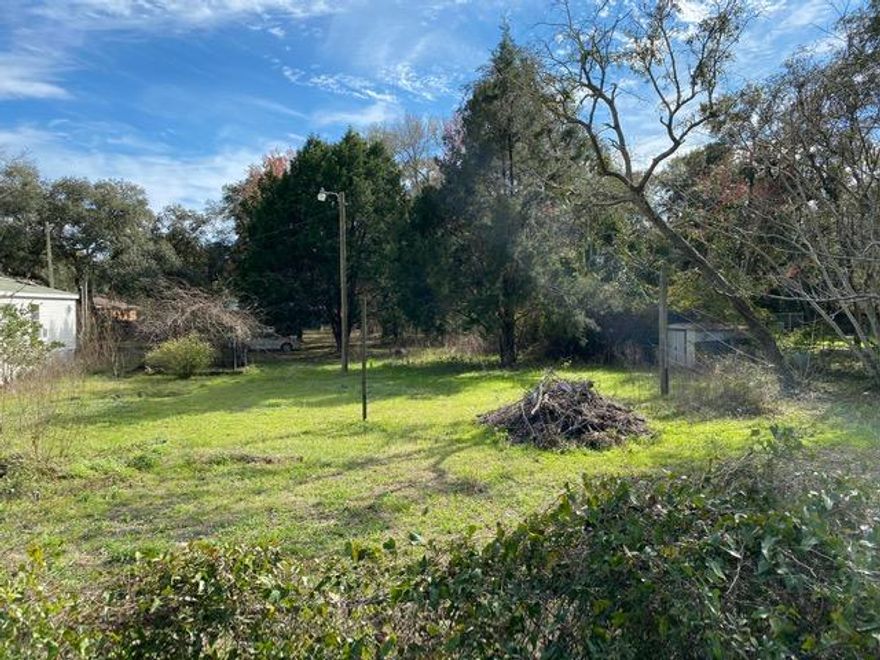 Located less than a 1/2 mile of Choctawhatchee Bay, between the cities of Niceville and Freeport, you'll find this secluded property. Nestled at the end of the street on the corner. Property is surrounded by a chain link fence. Mature Oaks and Magnolias provide plenty of shade for those hot Florida days. Enjoy a short commute to the beautiful white sandy beaches in Destin via the Mid-Bay Bridge. Close to military bases, shopping and schools. *The mobile home needs a lot of work, the value is in the location and land.