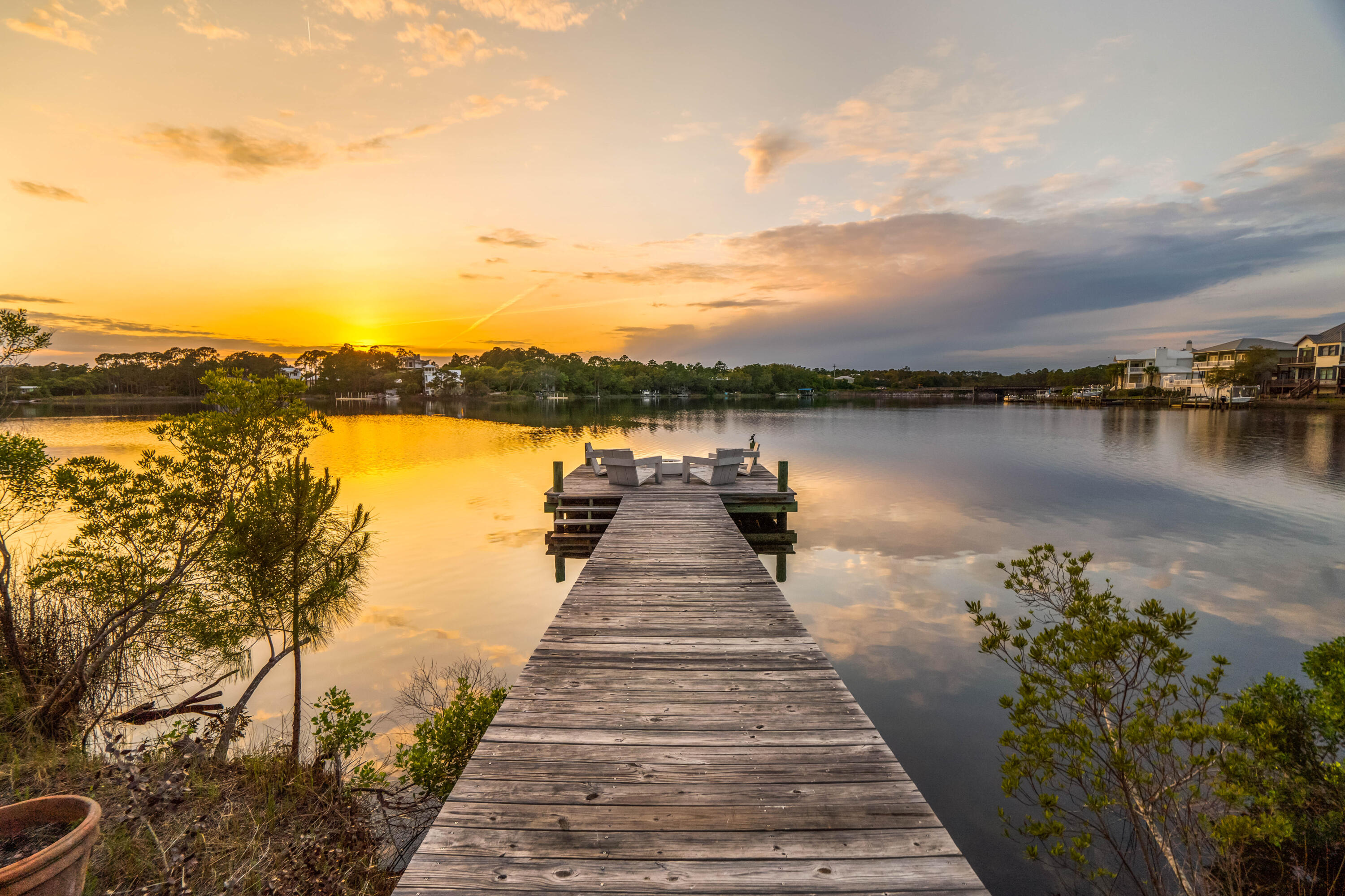 Welcome to your dream lakefront home on 30A! This stunning contemporary architecture home boasts 3 bedrooms plus a bunk room perfect for accommodating guests. Upon entering, you'll be amazed by the breathtaking views of the lake, with one side of the house practically being a glass wall. The outdoor space is equally impressive, featuring a lakeside pool, a pier with an outdoor fire pit, a second pier with a boat lift. Whether you're enjoying boating, paddle boarding, kayaking, or jet skiing, this property has everything you need to enjoy life on the lake. You can even paddle board or boat to the beach in just minutes! The gulf view from the property is simply stunning offering a unique combination of beach and lake house vibes this is the perfect home for anyone who wants to enjoy the best