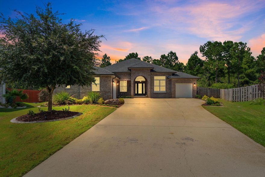 At the end of a quiet cul-de-sac on a premium lot, this exceptional residence blends craftsmanship, elegance, and modern comfort. A stately carriage-style 3-car garage and an extended driveway--large enough for 10 vehicles--set the tone for both convenience and grandeur. Inside, an expansive open-concept layout seamlessly connects the chef's kitchen and living area, where soaring coffered ceilings, refined architectural details, and designer light fixtures create an atmosphere of sophistication. The kitchen is a culinary masterpiece, featuring a gas stove, double ovens, and an oversized island perfectly suited for both gourmet preparation and impressive entertaining. A massive covered patio offers a breezy retreat, ideal for al fresco dining or cheering on your favorite team under the the Freeport sky. As part of the coveted Hammock Bay community, residents enjoy resort-style amenities including pickleball, multiple pools, a clubhouse, kayak launch, fitness facilities, and more. Located just 17 miles from the sugar-white sands and world-class shopping and dining of Walton County's beaches, this home delivers a true staycation lifestyle. Welcome to Freshfield Way...a fresh start in luxury living.