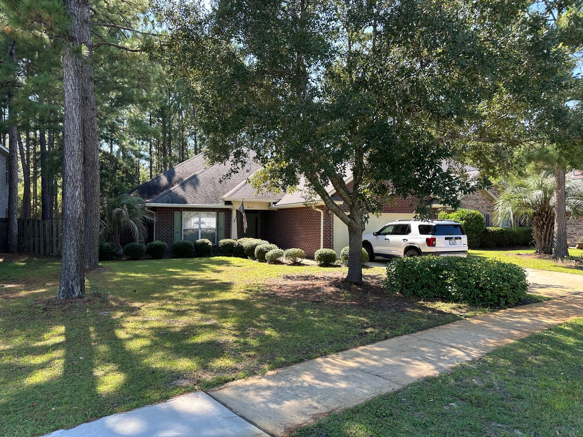A must see in Whispers at Hammock Bay. This immaculate four bedroom, two and one half bath home was built by well known Boswell Builders, and features 2318 sqft with an open concept floorplan and crown molding throughout. Renowned for the quality of construction, this home has a higher level of finishes and stands apart from others in the developed community. Enjoy the large great room which features a gas fireplace as the focal point along with its upgraded wood like tile floors. The custom built-ins with glass shelving border the fireplace, add a touch of class. The open kitchen features granite countertops, stainless steel appliances and plenty of cabinets and counter space. Just off the kitchen, the dining room displays beautiful, box trim wainscoting.