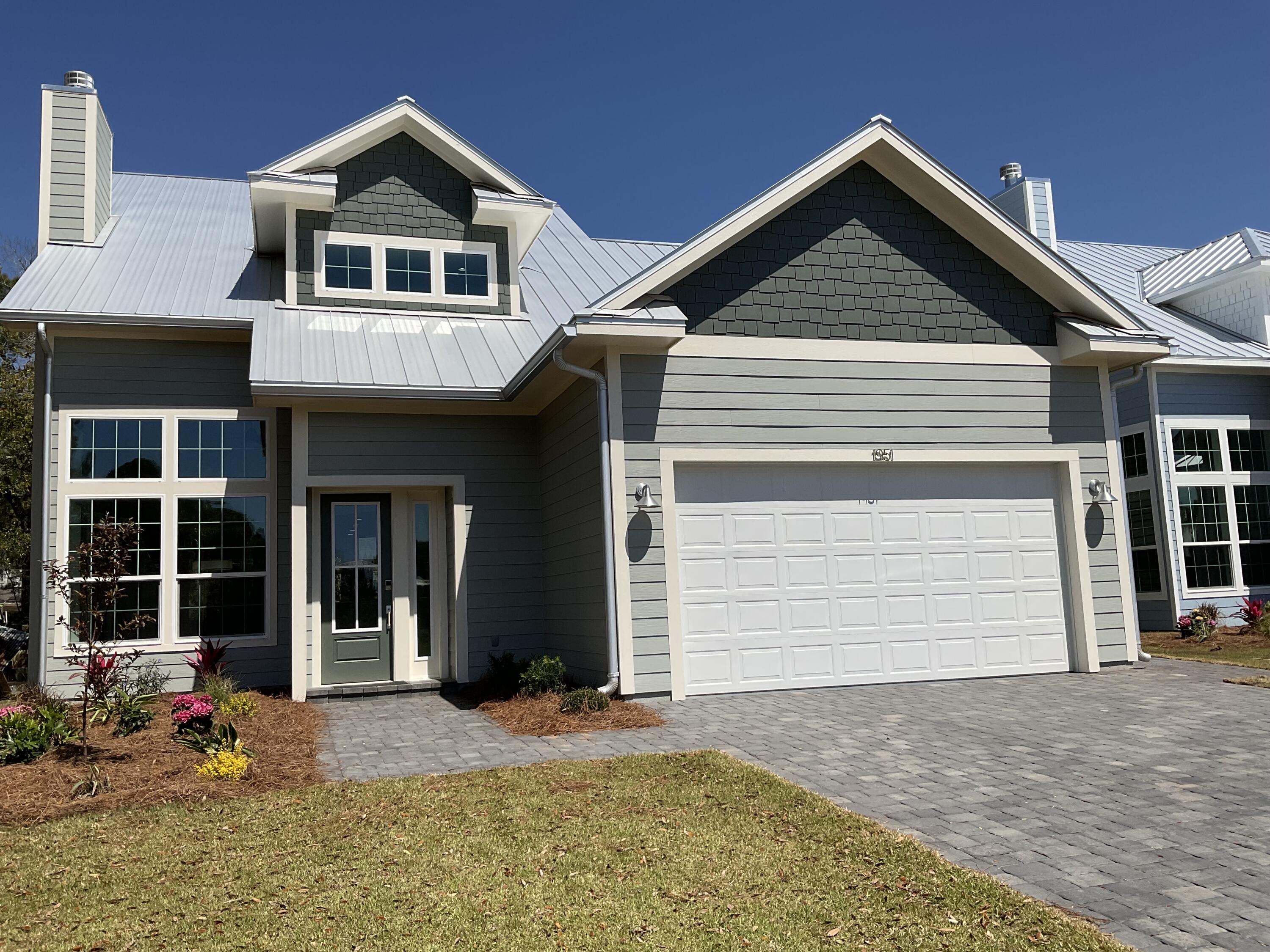 *Temp withdrawn new photos* Introducing one of eleven upscale, dockside homes with direct canal access to Hogstown Bayou and the Choctawhatchee Bay! This newly completed craftsman-style residence offers 4 bedrooms, 2 1/2 baths, beautiful craftsmanship, tasteful accents, and your own private dock on the canal, already prepped with power and water. Ideally located, you can choose to enjoy this peaceful home setting with fishing, boating, and just relaxing-or choose the fun activities and white sandy beaches. Only minutes from the 30A Beaches or Sandestin's Grand Boulevard; shopping, restaurants, recreation, and entertainment are a short drive away. Immediately upon entering the home, you are welcomed by warm wood composite flooring throughout the main level. The soaring ceiling in the livi area adds to the openness of this gathering space, complete with a wood-burning fireplace and windows everywhere! This amazing kitchen has everything you need with plenty of room for cooking and entertaining. The quartz countertops, custom cabinets, and stainless appliances flow gracefully together in this inviting space. The peaceful views of the canal from the dining area and the access to the paver patio outside invite you to relax with a good book or good conversation with friends. There's a powder room just off the kitchen and continuing around the corner, you will find the primary bedroom suite. With a cathedral ceiling, two closets in the bedroom and stunning views, you will feel at home in here. The en-suite includes double vanities, a roomy walk-in closet, a separate rain shower, and a private room with beautiful tub and toilet. The warm wood composite flooring continues from the main level up the stairs, leading to three generous bedrooms branching off from the second level landing. This home will appeal to both full-time residents and those seeking a second home in this remarkable community.