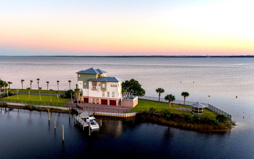Welcome to 34 Palms -- A One-of-a-kind Waterfront Oasis Redefining Luxury Coastal Living. Experience the pinnacle of Florida waterfront living at 6701 Yacht Club Drive, a remarkable 0.83-acre peninsula estate with 360 panoramic bay views and endless adventure come together. Perfectly positioned with water on all sides, this 4-bedroom, 5-bath, 4,125-square-foot home captures the essence of the Florida boating lifestyle -- where every sunrise, sunset, and gentle breeze reminds you that you've arrived somewhere truly special. A Boater's Paradise: With direct Gulf access from your backyard, 34 Palms is your personal gateway to the open water. Offering both a private dock and an additional community boat slip, this property was designed for those who love to live life on the water. The calm bay setting is also perfect for kayaking, paddle-boarding, and jet skiing, all from the comfort of your home. 

Outdoor Living at Its Finest:
Every inch of the estate was designed to celebrate outdoor living. Expansive decks and palm-lined walkways lead to multiple lounging areas ideal for entertaining or simply soaking in the serenity. Surrounded by lush tropical landscaping, this private oasis allows you to fish, paddle, or relax in complete tranquility  all while enjoying breathtaking 360?? views unique to its peninsula setting.

Elegant Interiors & Inspired Design:
Inside, natural light pours through floor-to-ceiling windows, illuminating open living spaces that seamlessly blend indoor and outdoor living. The heart of the home  a bright, modern kitchen and inviting living area  is perfect for both gatherings and quiet reflection, offering stunning water views from every angle.

Luxurious Private Retreats:
The primary master suite, perched on the top floor, provides a peaceful sanctuary with a private balcony, outdoor shower, and sweeping sunrise-to-sunset views. A third-floor guest suite offers its own ensuite bath and walk-in closet, while two additional bedrooms share a charming Jack-and-Jill bath ideal for family or guests. A three-car garage with an office or workshop space completes the thoughtful layout.


Key Features

-0.83-acre peninsula lot with water on all sides

-Over 500+ of Waterfront

-Private dock plus community marina boat slip

-Direct Gulf of Mexico access for boating and fishing

-Expansive 4,125 sq. ft. of light-filled living space

-Multiple decks and outdoor entertaining areas

-Lush tropical landscaping 

-Waterfront Gazebo with Private Beach 

-Largest lot in East Bay Preserve

More than a home, 34 Palms is a lifestyle  one defined by endless horizons, outdoor adventure, and effortless elegance. Discover unparalleled waterfront living where every day feels like a getaway.

Schedule your private tour today and experience how 34 Palms redefines luxury coastal living.
