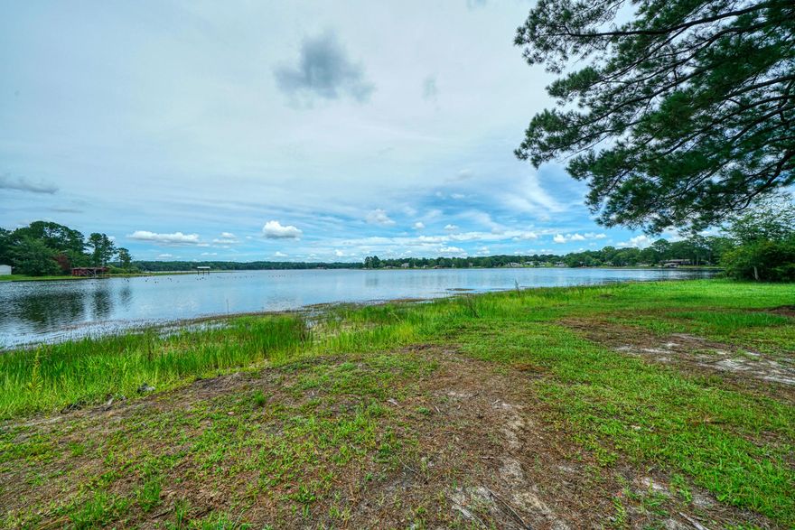 Beautiful. Quiet. Peaceful. Don't miss the chance to own this one-of-a-kind Juniper Lake Waterfront Lot! This lot has been selectively cleared and is ready for you to build your dream home. All utilities are on the property (water, septic, electric) and a large storage building/workshop also conveys with the property. Juniper Lake is a State Managed lake and is known for it's record bass and bream. This lot is located at the end of a cul-de-sac in a well established neighborhood. The views from this lot are breathtaking. There is an RV on the lot and it  does not convey but it can be negotiated with an offer.  This one won't last long, call for your tour today!