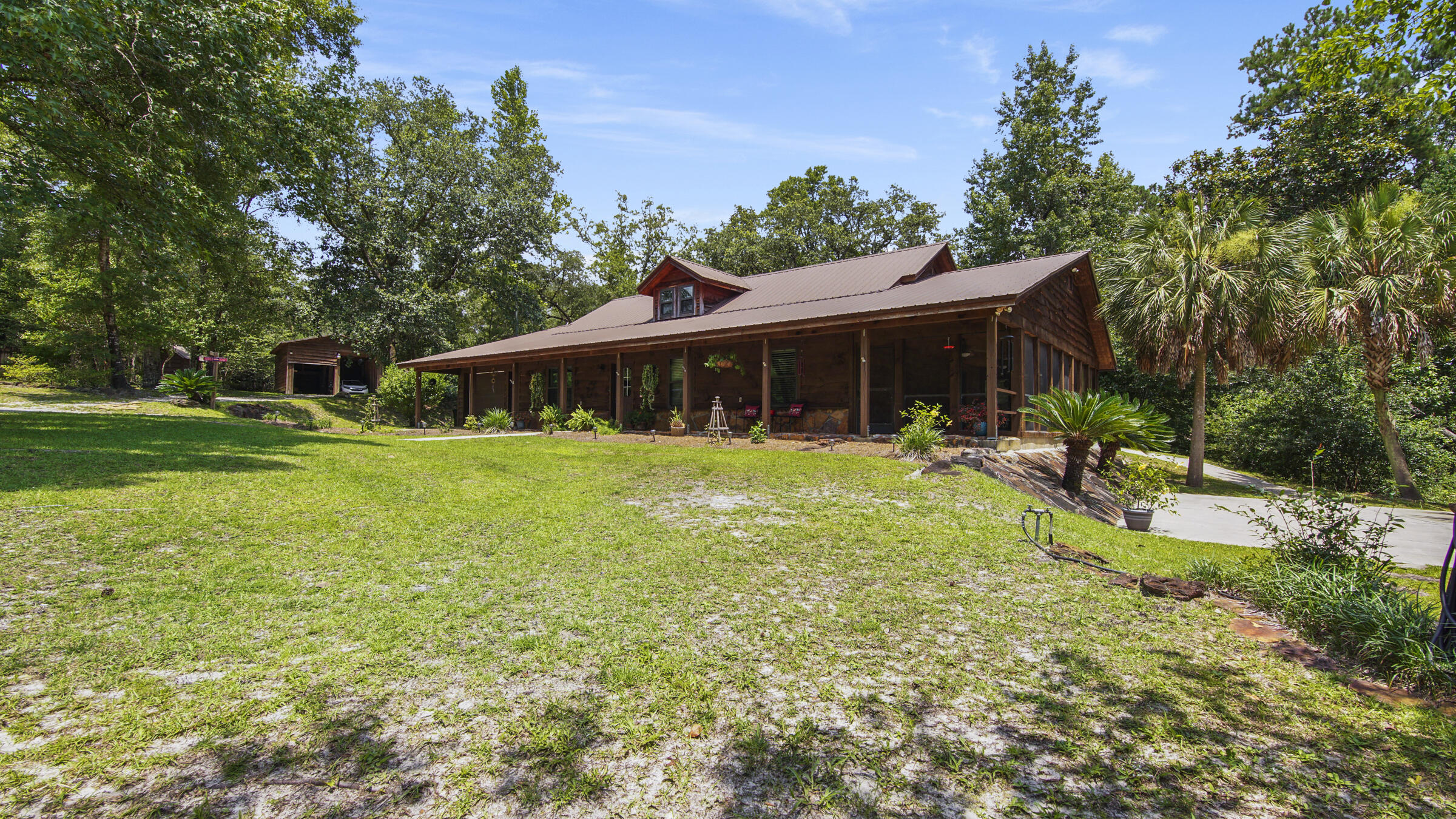 Welcome to 3809 East State Highway 20. A park like setting that is one of a kind. This 11.81-acre homestead, lovingly known as Gypsy Wilde Farm, offers Old Florida charm and beauty that is close to everything Walton County Florida is famous for. Here you will find a thoughtfully developed and useable property that you will never want to leave. The Farm is highlighted by a list of must haves. There is a large Garden inside a high fence with a Greenhouse, positioned next to an Orchard with a variety of fruit trees. Two ponds are situated amongst green, manicured grass and are stocked with Bass and Bream. The year-round Creek with a walking trail runs through the length of the property. Multiple out buildings include a Barn/Workshop with ample storage inside/out and parking under roof, an RV