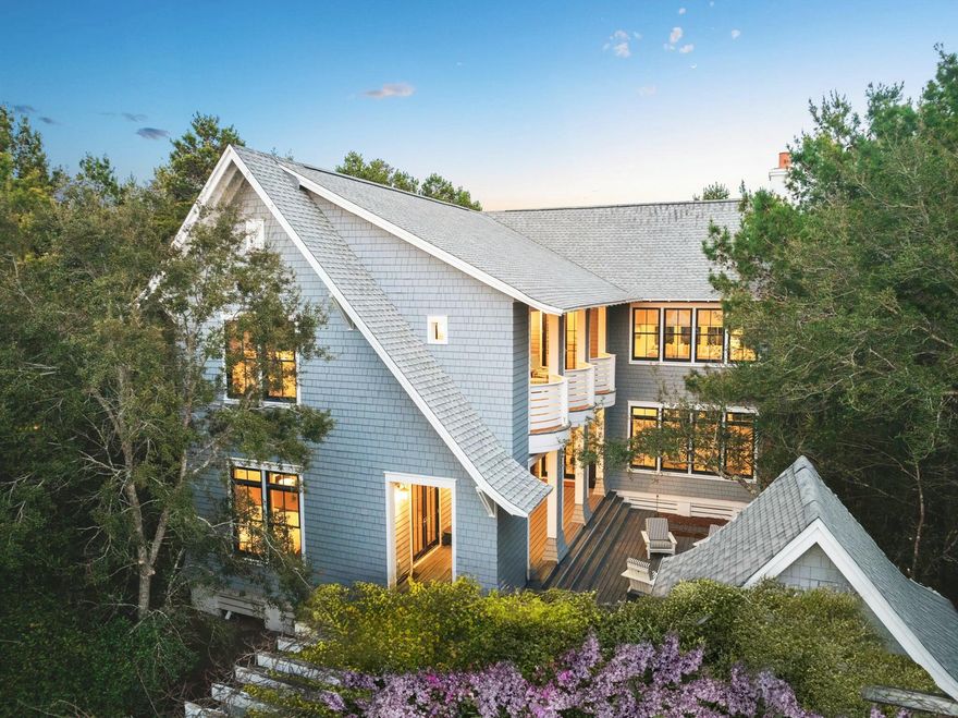 Welcome to a coastal modern masterpiece where the serene beauty of the beach meets sophisticated design. This one-of-a-kind Richard Fouquet and Dawn Thurber collaborative creation is nestled in the exclusive Peninsula section of WaterSound Beach, boasting only 35 home sites for ultimate privacy. Step inside to an open-concept layout featuring gracefully elevated ceilings and a stunning living room with vaulted accents highlighted by a cozy gas fireplace. With hardwood flooring, a state-of-the-art Sonos system, and interiors inspired by the tranquil hues of nature, every detail invites the outdoors in for an unparalleled living experience. The gourmet kitchen dazzles with top-tier Viking appliances, exquisite St. Charles cabinets, and a dramatic 10-ft island that serves as the heart of culinary adventure. Striking Murano glass pendant lights add an artisanal touch overhead, perfect for both cooking and entertaining. This innovative reverse floor plan offers the unique option of an upstairs or first-floor primary suiteboth featuring dual vanities. The upstairs primary suite further impresses with vaulted ceilings, creating a serene retreat for rest and relaxation. Every bedroom in this residence is designed for ultimate comfort, with all four bedrooms boasting their own ensuite bathrooms. Outside, enjoy 1,400 square feet of expansive covered porches that seamlessly blend indoor and outdoor living, an exterior shower perfect for rinsing off after a day at the beach, and an outdoor shed ideal for storing bikes and gear. There's even room for a garage and a pool to complete this exceptional property. Experience coastal living redefined where the beauty of the beach becomes an integral part of your home.
