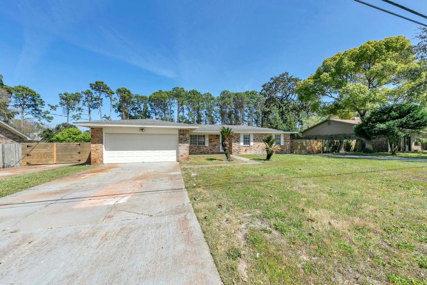 If you've been waiting for the perfect Kell-Aire Gardens home, look no further! This all-brick ranch home is the perfect haven for creating lasting memories. The home features an inviting wood-burning fireplace and an open floor plan, ideal for entertaining family and friends. Step out through the French doors onto the expansive deck, which seamlessly connects to an expansive back yard, perfect for warm days and family gatherings. This lot offers ample space and privacy for both family and pets to enjoy the outdoors. Additional features include two gated parking pads on either side of the driveway, accommodating RVs, work trucks, boats, and sporting equipment. This unique home is a must-see for anyone seeking a warm, welcoming space in the heart of Destin.