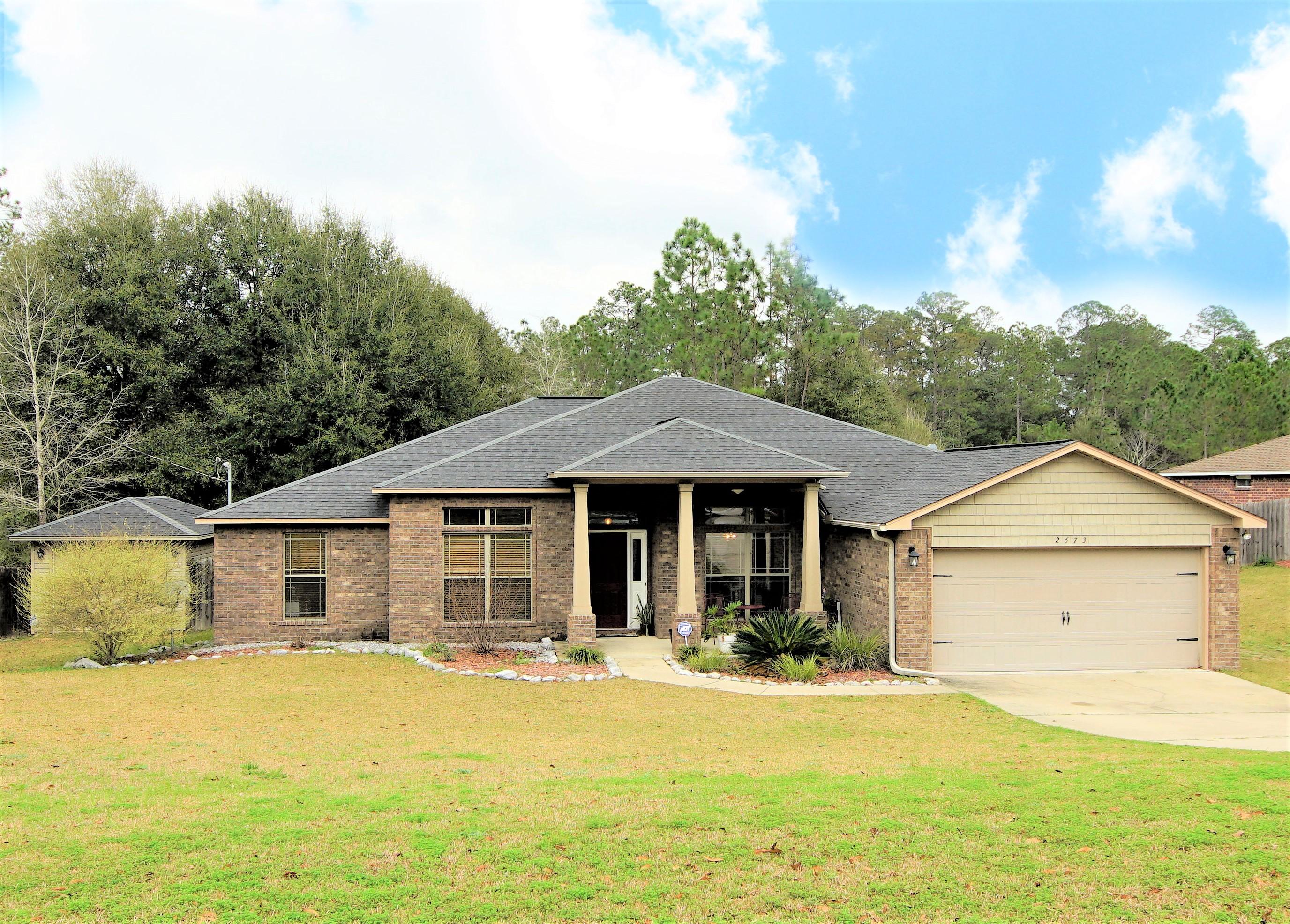 Looking to get away from those crowded neighborhoods? Need room to spread out? This 5 bedroom home located on 3/4 acre has all that and more. Entering the home, the entry and formal dining room open to an oversized living area with room for your sectional, highlighted by a custom wood accent wall. Bonus room along the back of the home can be used for a den, office or playroom, and can be shut off with the custom sliding (barn) door. Check off your wish list with the large kitchen: granite, stainless appliances, plentiful wood cabinets, and an island work area. Split bedroom plan - master suite and guest bedroom and bath both separate. The lot backs to a 47 acre natural area with a creek flowing directly behind the property. Would you like your own fresh eggs and garden veggies? There is a