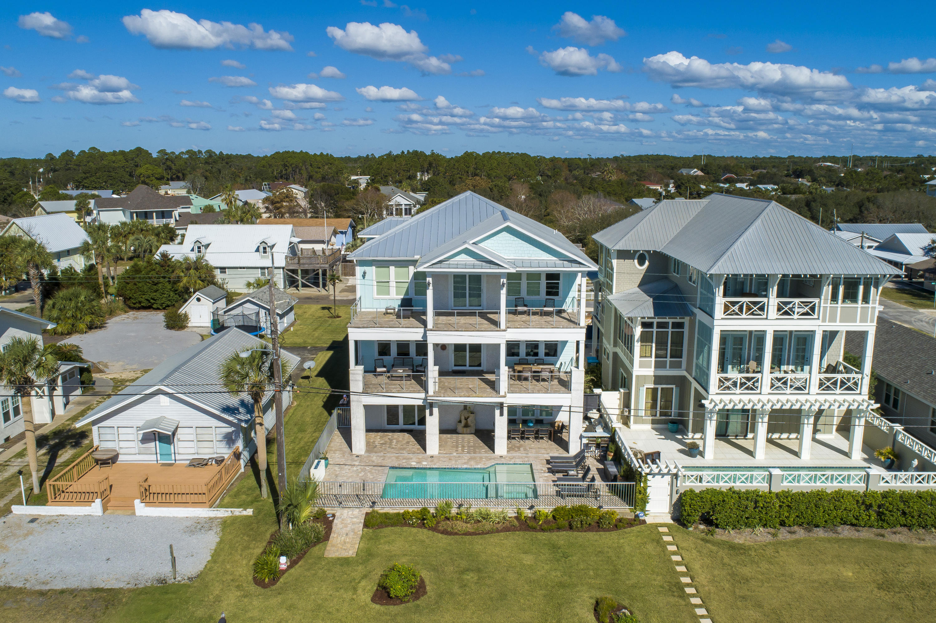 An absolute stunner of a CUSTOM built home with upgrades and views galore. This 5 bedroom, 4.5 bathroom home with over 4,800 square feet is perfectly located in Sunnyside featuring forever gulf views overlooking 10 acres of private beach that will never be developed. The construction details are endless including a solid concrete 1st floor, zip system waterproof construction, anodized aluminum pool & balcony railings and a standing seam aluminum roof with straps and roof deck in excess of what code required.  Enjoy the phenomenal custom upgrades in the home including custom solid wood cabinets throughout, a private pool, 1st floor game room, elevator, quartz countertops, tricked out 3 car garage with enough driveway space for all of your toys.