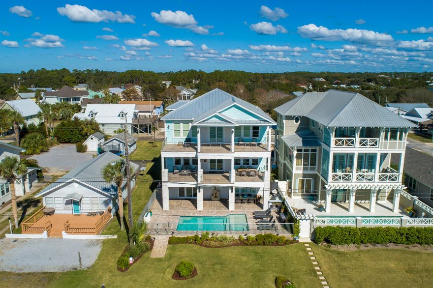 An absolute stunner of a CUSTOM built home with upgrades and views galore. This 5 bedroom, 4.5 bathroom home with over 4,800 square feet is perfectly located in Sunnyside featuring forever gulf views overlooking 10 acres of private beach that will never be developed. The construction details are endless including a solid concrete 1st floor, zip system waterproof construction, anodized aluminum pool & balcony railings and a standing seam aluminum roof with straps and roof deck in excess of what code required.  Enjoy the phenomenal custom upgrades in the home including custom solid wood cabinets throughout, a private pool, 1st floor game room, elevator, quartz countertops, tricked out 3 car garage with enough driveway space for all of your toys.