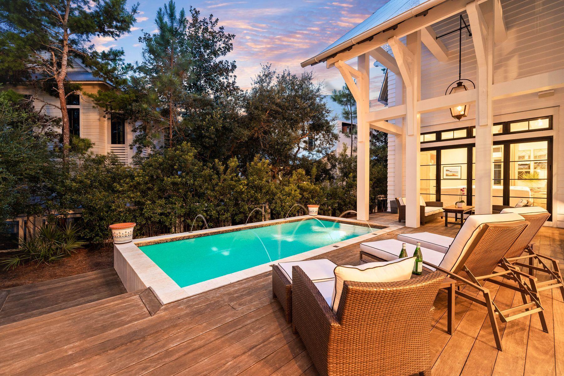 Discover unparalleled luxury in this exquisite WaterColor home, artfully designed by the renowned Geoff Chick. Built in 2014, this stunning residence offers a blend of elegance and comfort, making it a perfect choice for a full-time residence or a second home. Located on Sand Hill Circle, this property features a spacious main house with a private pool, a carriage house and exceptional outdoor living spaces. Upon entering, you'll be captivated by the open-concept design and the seamless transition between indoor and outdoor living areas, thanks to the folding glass doors that open to the outdoor sitting area. The real hardwood floors throughout the living and bedroom spaces add a touch of warmth and sophistication.
