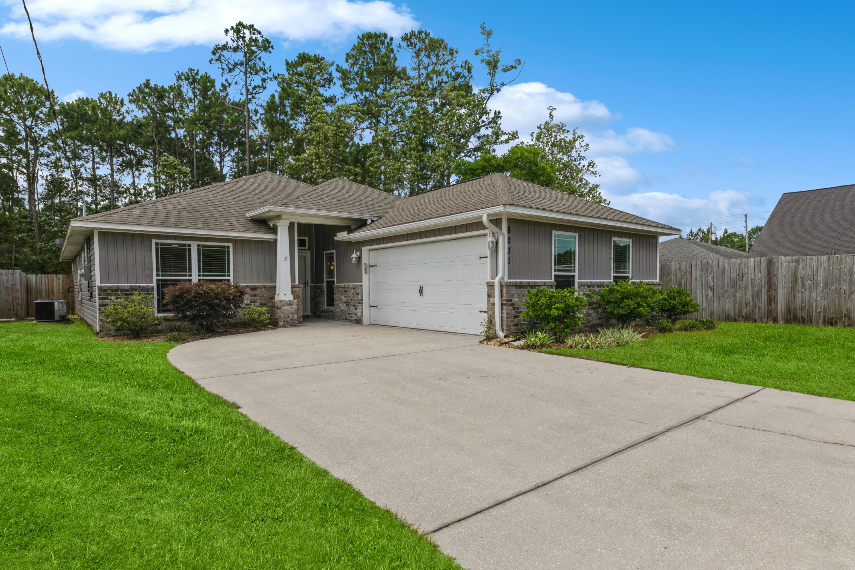 **Open House this Sunday the 6th from 12:00 - 2:00** Introducing 8231 Sierra Street, Navarre in the beautiful NW Florida Emerald Coastal area!  This stunning home offers a host of upscale features that are sure to impress. Step inside to discover a kitchen adorned with beautiful granite countertops, enhanced by recessed lighting for a warm ambiance, an open kitchen concept with a spacious island and an extended length hop-up bar top overlooking the dining room to host special meals and a walk-in pantry providing convenient storage. Enjoy the expansive 16'x18' family room, offering a comfortable space for gatherings and bedrooms generously sized, ensuring plenty of room for rest and relaxation.