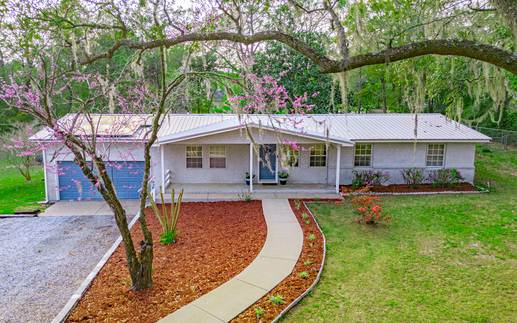 Charming 3 BD/2BA, 1456 SqFt home on 1.01 acres!. New plumbing (2023), new water heater, HVAC & metal roof (2017). Remodeled in 1993 with a master bedroom/bath and 2 car garage addition. Features include owned solar panels with battery backup ensuring constant power, updated kitchen with stainless steel appliances (less than 3 years old), and a fenced backyard surrounded by beautiful landscaping. Don't miss out on this delightful property! 12 month power bill avg $84.69, 12 month water bill avg: $48.12
