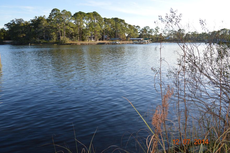 This is a great 3/4 acre lot with majestic moss draped oaks and large southern magnolia trees providing an elegant backdrop to the deep waters of Hewitt Bayou. This is an ideal setting for the home you've dreamed of. Envision a long winding drive shaded by ancient hardwoods that will lead to your new home backing up to deep water that opens all the way from the end of the bayou to Choctawhatchee Bay. This lot is perfect for those who love the natural beauty of the bayous and waterways we all enjoy. Great fishing in a gated community with the shopping of Silver Sands and Grande Boulevarde close by as well as numerous golf courses and tennis courts.