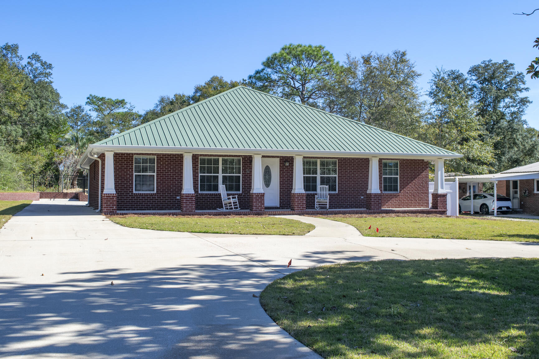 **PRICE IMPROVEMENT**Located between the desirable Poquito Bayou and Longwood neighborhoods, this 4-bedroom, 2-bathroom home offers an open floor plan with nearly 2,000 square feet of living space. Built in 2014, the property features volume ceilings, a metal roof, and a tankless water heater. The spacious primary suite includes a tray ceiling, walk-in closet, and direct access to the screened-in back porch.Additional highlights include LVP flooring, recessed lighting, ceiling fans, and a flexible room that could serve as an office or studio. The kitchen opens to a screened back porch through double French doors, perfect for indoor-outdoor living. Enjoy a private, fenced backyard with an updated in-ground pool featuring a brand-new liner, pump, filter, and surrounding deck. The 2-car carport includes an 8x12 enclosed storage space with a doggy door that leads to a fenced dog run. Circular driveway and large lot provide plenty of parking and room to spread out.