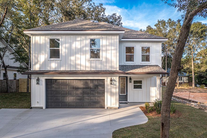 This Beautiful 4 bedroom, 2 1/2 bath home is located in the heart of Niceville, yet beautifully secluded at the end of a one way street on a corner lot.    This home has many custom features.  The bedrooms are LARGE and have walk -in closets. If you like entertaining, you'll love this OPEN FLOOR PLAN, featuring 9 ft. ceilings throughout, an oversized garage 27.6x22.8, extra parking pad, upgraded spray foam insulation in the roof.  The kitchen is divine with white custom cabinets, soft close drawers, upgraded sink, gas stove, walk in pantry and quartz countertops throughout. Enjoy the upgraded lighting, floor plug in the family room, and oversized pantry with extra shelving.  This home is perfect for entertaining.  The family room and kitchen opesn up to