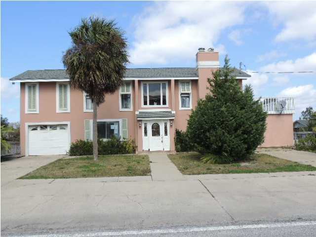 Location, Location, Location! This bright and airy 4 bedroom, 2.5 bath waterfront home is located on Holiday Isle! Not only is this home waterfront, it is on a deep water canal with a boat dock behind your large deck with in-ground pool. The home has beautiful hardwood and tile floors, as well as cathedral ceilings and plenty of room for all your guests! Property being sold ''AS IS'' with right to inspect.