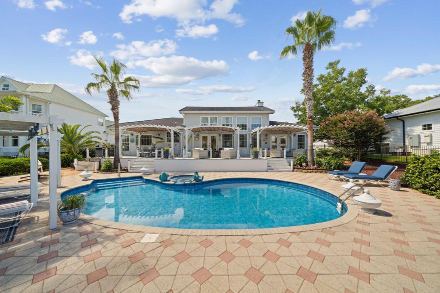 Welcome to your waterfront paradise in the heart of Destin--a dream come true for boating enthusiasts! This exceptional property is tailor-made for those who love the water, offering a deep-water, protected safe harbor ideal for multiple vessels. The home's impressive boat dock features four slips equipped with water and electricity, and one includes a brand-new, remote-controlled lift, ensuring convenience for all your boating needs.Designed with entertaining in mind, the backyard is an entertainer's dream.  With three tiers of beautifully crafted outdoor spaces, you'll have endless options for hosting elegant gatherings or intimate soirees. The newly expanded boat dock area provides generous waterside entertaining space, complete with a charming gazebo with TV and cozy fire pit for evenings under the stars. For a more relaxed energy, unwind by the stunning, newly updated saltwater pool while taking in the breathtaking views of the Bayou.  Lounge on the spacious upper deck featuring multiple dining and seating areas beneath adjustable shaded pergolas.  Inside this one-story stucco home, you'll be greeted by an inviting open floor plan with high ceilings and abundant natural light that pours through windows framing the picturesque waterfront.  The entertainer's gourmet kitchen, complete with granite countertops and an oversized island, flows seamlessly into the spacious living room with a cozy fireplace, making this home ideal for both everyday living and hosting.  The thoughtful layout ensures that almost every room in the house enjoys sweeping views of the Bayou. The circular driveway adds both curb appeal and ease of parking for guests. Plus, located in Flood Zone X, flood insurance is not required offering peace of mind along with the luxury of waterfront living.  Don't miss the opportunity to own this spectacular waterfront gem that perfectly blends the boater's lifestyle with the ultimate in luxury and relaxation. Schedule your private showing today to experience all that this Destin treasure has to offer!
