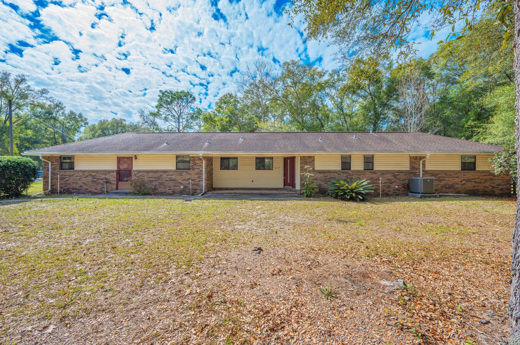 ONE ACRE, CORNER LOT, in Kennedy Lakes Subdivision! NO HOA. Conveniently located in the heart of Crestview w a short commute to bases. Solid 2 bd/2 bath custom home, a fresh coat of paint & new flooring will bring this gem to a beautiful shine! Covered front & back porches offer a nice place to enjoy the scenery all around. Spacious eat-in kitchen w pantry and cabinets galore. Wood burning stove sits on brick hearth with brick accent wall in the living area. Large primary suite boasts 3 closets, sliding door to the covered porch, Primary bath w walk in shower, double vanities and linen closet. Backyard is partially fenced, with storage shed/workshop for your hobbies. Garage has enclosed laundry room and work bench area with lots of cabinets, there is also a storm shelter with ventilation to give cover for tornadoes when they threaten our area. Being sold "as is". Put this on your listing to see today!
