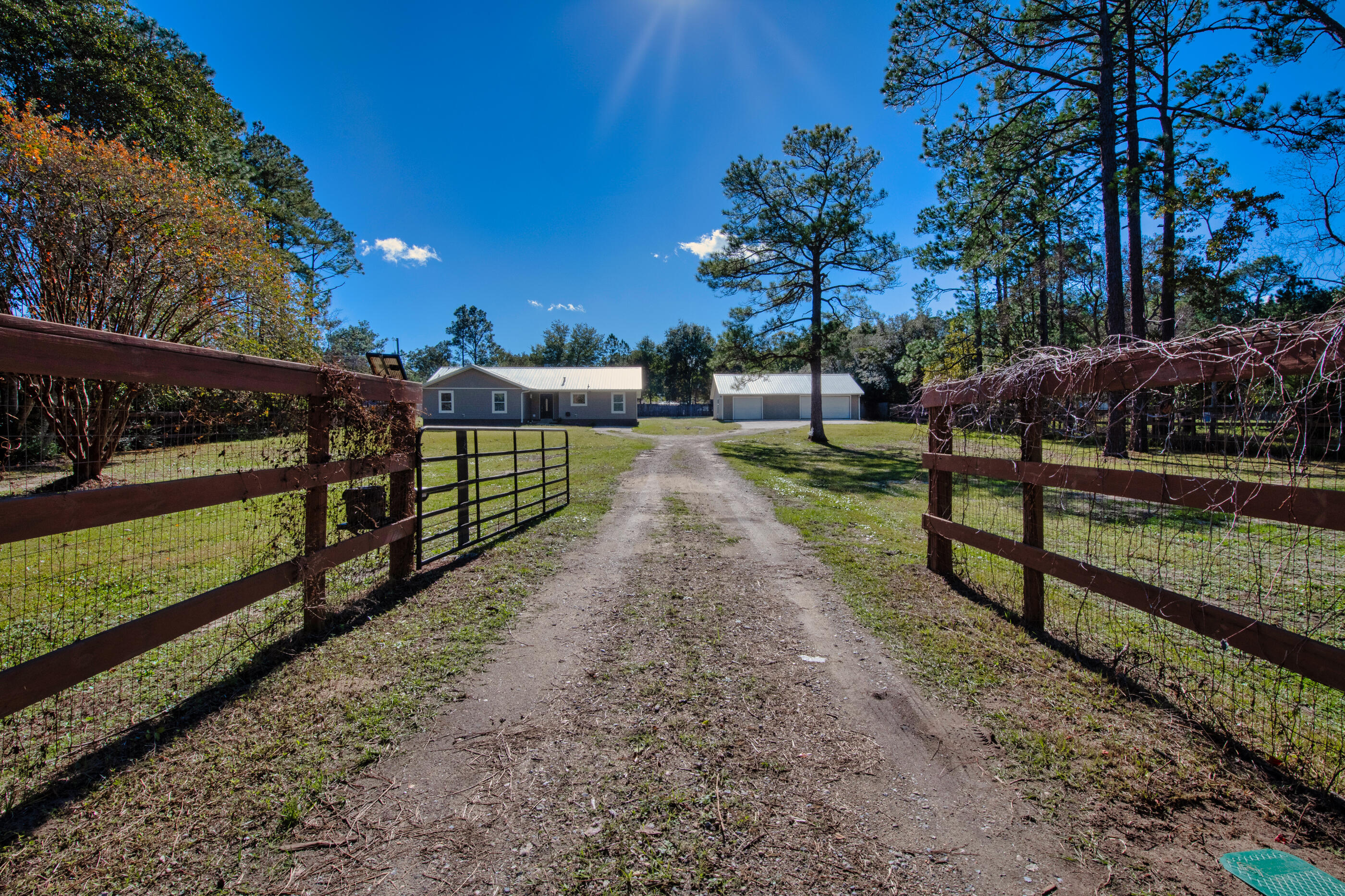 The word of the day is SPACE!!! This East Navarre pool home has space inside and outside!! It sits on over an acre of land, offering the perfect blend of privacy, comfort, and convenience. Whether you're looking for room to stretch out or entertain, this property has it all both inside and out.Outside you'll find a sparkling enclosed pool and 6 person hot tub, surrounded by a large patio and plenty of space for summer BBQs, lounging, or hosting those epic pool parties you've always dreamed of. The massive yard gives you room to add a garden, playground or just enjoy the room to roam, the possibilities are endless! There's a 4 car detached, divided garage with separate driveway to store your toys or use as a workshop or you could even finish it in for another living space. This property is fully fenced (front and back) with an electric gate at the street. 
Step inside to find an open, airy layout filled with natural light. You'll find a generously sized living area with a fireplace and shiplap, newly renovated kitchen with beautiful cabinets and backsplash, and cozy bedroomsperfect for relaxing after a day in the Florida sun. This home is not short on storage with a huge pantry in the kitchen, extra cabinets in the laundry room and hallway linen closets. Don't forget the heated and cooled Florida room, with so much natural light you'll feel like your outside but have the comforts of AC.
You'll have peace of mind with a new roof and water heater as well as wind rated doors and windows along the south side of the home. Located in East Navarre, you're just minutes from shopping, dining, schools, YMCA, the NYSA sports complex, Navarre's gorgeous beaches and only 20 minutes to Hurlburt. But don't worry, with over an acre of land to call your own, it feels like you are in the country even though you're in the heart of all the action.
Don't miss out on this rare opportunity to own a pool home on acreage and start living your best Florida life!