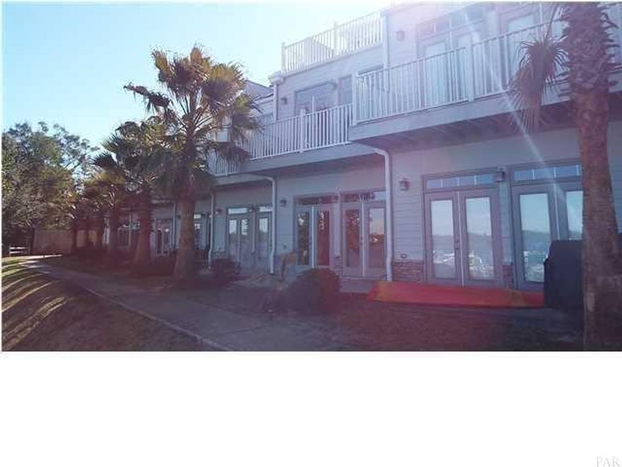 RARE FIND!!! Waterfront townhouse in Navarre. This beautiful home sits on East Bay with majestic views from all 3 levels. As you enter on the ground floor from the 1 car garage, you immediately notice the wonderful tile and wood floors. Main living, kitchen/dining and 1 bedroom and full bath on the first floor offer plenty of space to spread out. On the second floor you will find the Master's Retreat with double doors opening up to the balcony that overlooks the Bay. Also on the second level is the guest bedroom and guest bathroom. The 3rd floor is an open loft with wet bar. Kitchen is equipped with stainless steel appliances including a brand new refrigerator, dishwasher and built-in microwave. Community has pool and is located across the street from Hidden Bay Golf Course.
