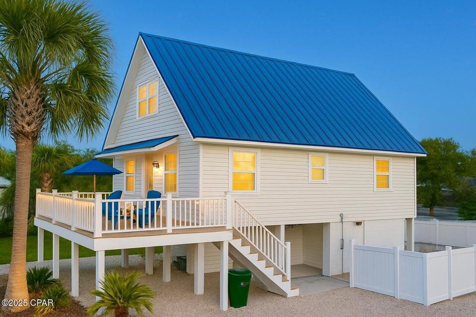 Get ready to embrace the ultimate coastal lifestyle in this stunning 4-bedroom, 2-bathroom home, perfectly positioned for breathtaking lagoon views and just a leisurely stroll to the Sugar Sandy Gulf Beaches! This gem is Turnkey ideal for your sun-soaked summer getaways or as a profitable rental investment. Equipped with luxury vinyl plank custom flooring throughout, a beautiful kitchen island complemented by a chic glass backsplash, and stainless-steel appliances that bring both elegance and functionality. Plus, enjoy the convenience of a full-size stackable washer and dryer! Ideal Coastal Living Nestled in a golf cart-friendly neighborhood, you're just one block from the tranquil lagoon and only three blocks from the sparkling Gulf. Dive into endless aquatic adventures and memorable beach days with family and friends! Outdoor Oasis set on a spacious corner lot, the vinyl-fenced backyard offers ample room for outdoor fun, barbecues, and lounging under the sun. You'll also appreciate the generous parking options with a covered garage (12.5' x 25') and an additional lock-out unit for your convenience. Boater's Paradise just blocks away from a community boat ramp, this home provides easy access for exploring the beautiful local waters with your boat! Convenient Amenities with delightful local restaurants and shopping options just around the corner, everything you need is within easy reach, making life a breeze! Modern Upgrades enjoy peace of mind with vinyl impact windows, stylish plantation shutters, a durable metal roof, and a composite front deck with elegant stairs that elevate the home's curb appeal. Fully Furnished this home comes furnished (minus personal items), ensuring a smooth transition into your new beachside lifestyle! Don't let this incredible opportunity slip away! Whether you're after a summer retreat, a lucrative rental investment, or your forever coastal home, this property is ready to make your dreams a reality. Contact us today for a private showing and step into your new coastal haven!