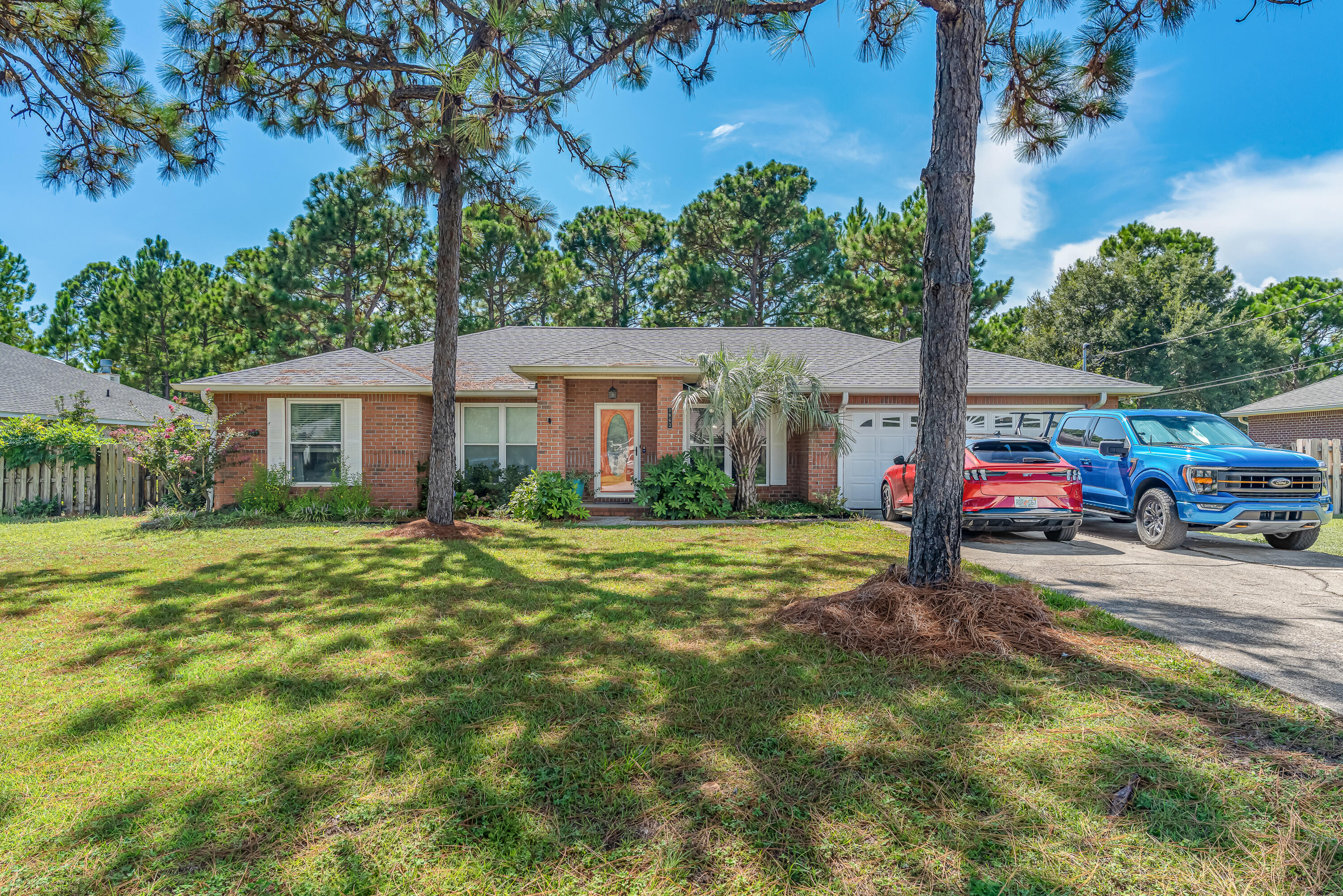 Located in the sought-after Holley by the Sea subdivision, this inviting 4 bedroom, 2 bath home sits on a half-acre lot with plenty of space inside and out. The spacious master suite offers a private bath and walk-in closet, while the additional bedrooms are generously sized for comfort.You'll love the luxury vinyl plank flooring throughout the living, dining, flex room, and bedrooms--both stylish and easy to maintain. A versatile flex room adds even more options, whether you need a home office, formal dining space, or playroom.Step outside to the screened-in patio with shades is the perfect spot to relax while overlooking the backyard. There's plenty of green grass for kids or pets to play, along with a wooded area that's just right for a firepit and backyard camping. This home is all about comfort, flexibility, and a lifestyle you'll love. For peace of mind, the roof and hot water heater were updated in 2020, and the HVAC in 2018. Plus, living in Holley by the Sea means access to incredible amenities including pools, tennis courts, a fitness center, playgrounds, and waterfront access.