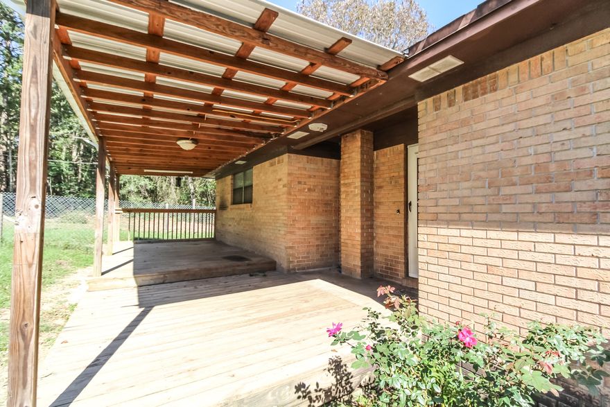 If you are looking for acreage and want an awesome workshop don't miss out on this two bedroom, 1 bath brick home on over 5 acres, approximately half cleared and half left in its natural state allowing for the preservation of nature and for the true enjoyment of country living. Home boasts new living room flooring, covered front and back porch with hurricane strapping, and bathroom recently upgraded with tile. Covered back deck and fencing surrounds the home for your children and pets. Property has a 4'' well (360' deep) AND a 30x30 (900sqft) workshop with concrete slabbed floor, electricity, and roll up door. New pump house. Survey available. Schedule a showing today!