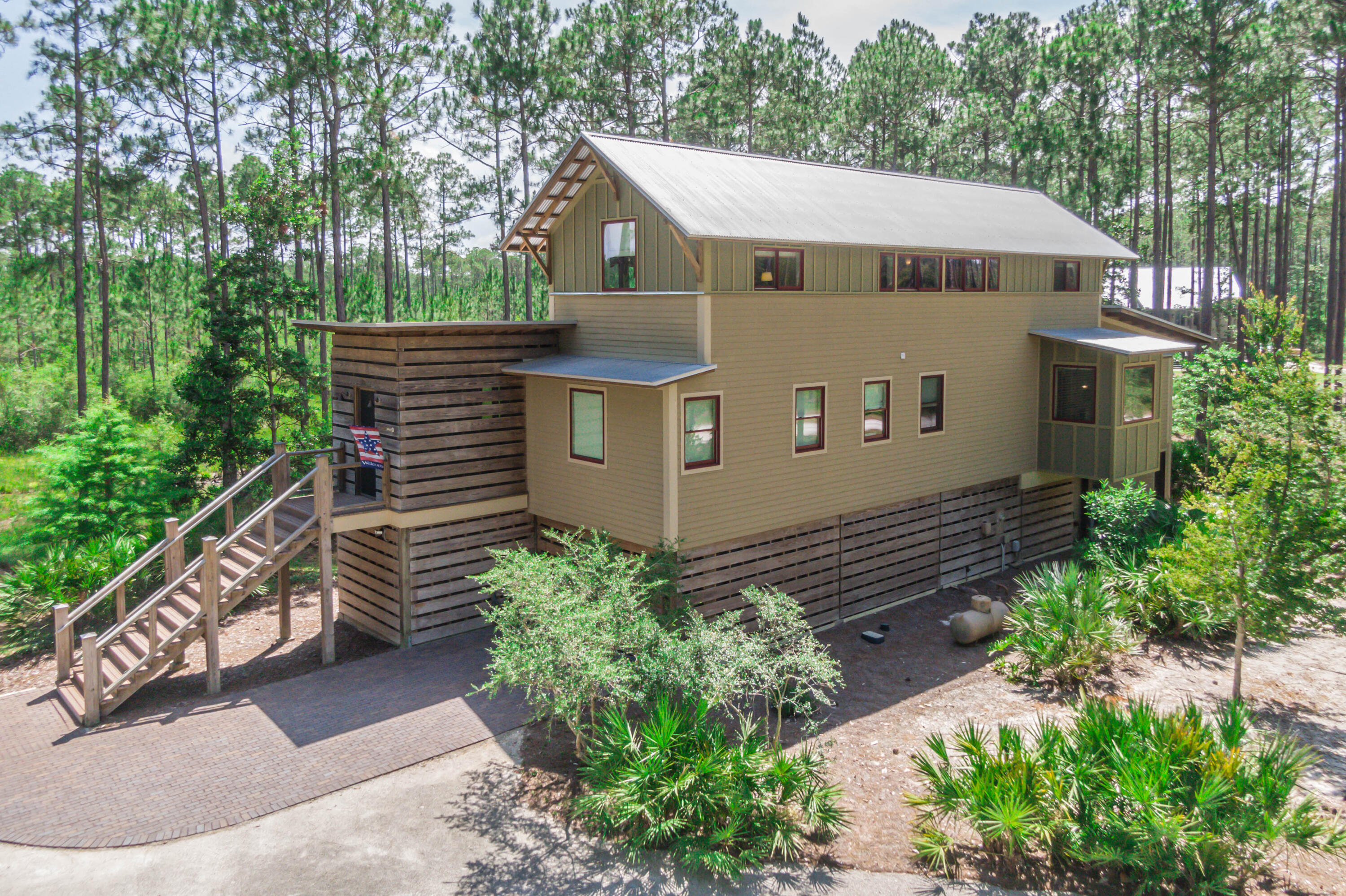 Straight out of a magazine! We're not kidding; this house is based on a Southern Living Home, and it is picture-perfect and more! Not one thing wasn't thought of in the design and construction of this perfectly located home. With the famous Florida woods surrounding, a private boat slip right on the bay, a massive bayside pool, pickle-ball court, fitness center, and family areas, you never have to leave! The benefits of living here are endless. This is the lifestyle you've always dreamed of, so why not live it!With hand scraped aged bourbon wood throughout the home. This house is strategically positioned for seclusion and serenity from neighboring lots. No one can build behind this house and views of other properties are dismal.