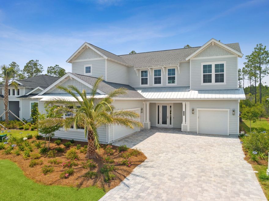 An entertainer's dream awaits, tucked about a quiet cul-de-sac buffering peaceful nature preserve, where your paradise can be found right here in Watersound! This new 5 bedroom, 4 bath home is an absolute stunner, equipped with an incredible pool, spa, and 3 car garage! From the moment you walk through the front door, you're met with a striking 22 foot high canopy anchored by a floor to ceiling fireplace, making the perfect focal point, drawing the eye up to the custom coffered ceiling setting the tone for this impressive residence! These craftsman details are echoed throughout the home, and create a seamless flow with this builder's top-tier design, customized to meet the needs of a discerning family, and would make for an incredible secondary home fit for the perfect Florida lifestyle!