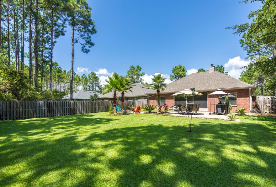 What a great place to call ''HOME''!! Located in the Symphony subdivision of Hammock Bay, this home sits on a beautiful lot next to the culdesac, on a very quiet street, and has one of the prettiest yards around! This home has 3 bedrooms and 2 baths, a covered and screened-in rear lanai, and a beautiful fenced-in backyard with plenty of patio space and a firepit that's perfect for outdoor entertaining! The lot is backed up to a wooded area so you have the privacy of not having anyone behind you. The Master Bedroom is very spacious and has a trey ceiling to give it that extra bit of height and the home has upgraded black stainless steel appliances that are included in the sale of the property. CDD fee has already been paid. Buyer to verify all dimensions and perform their due diligence.