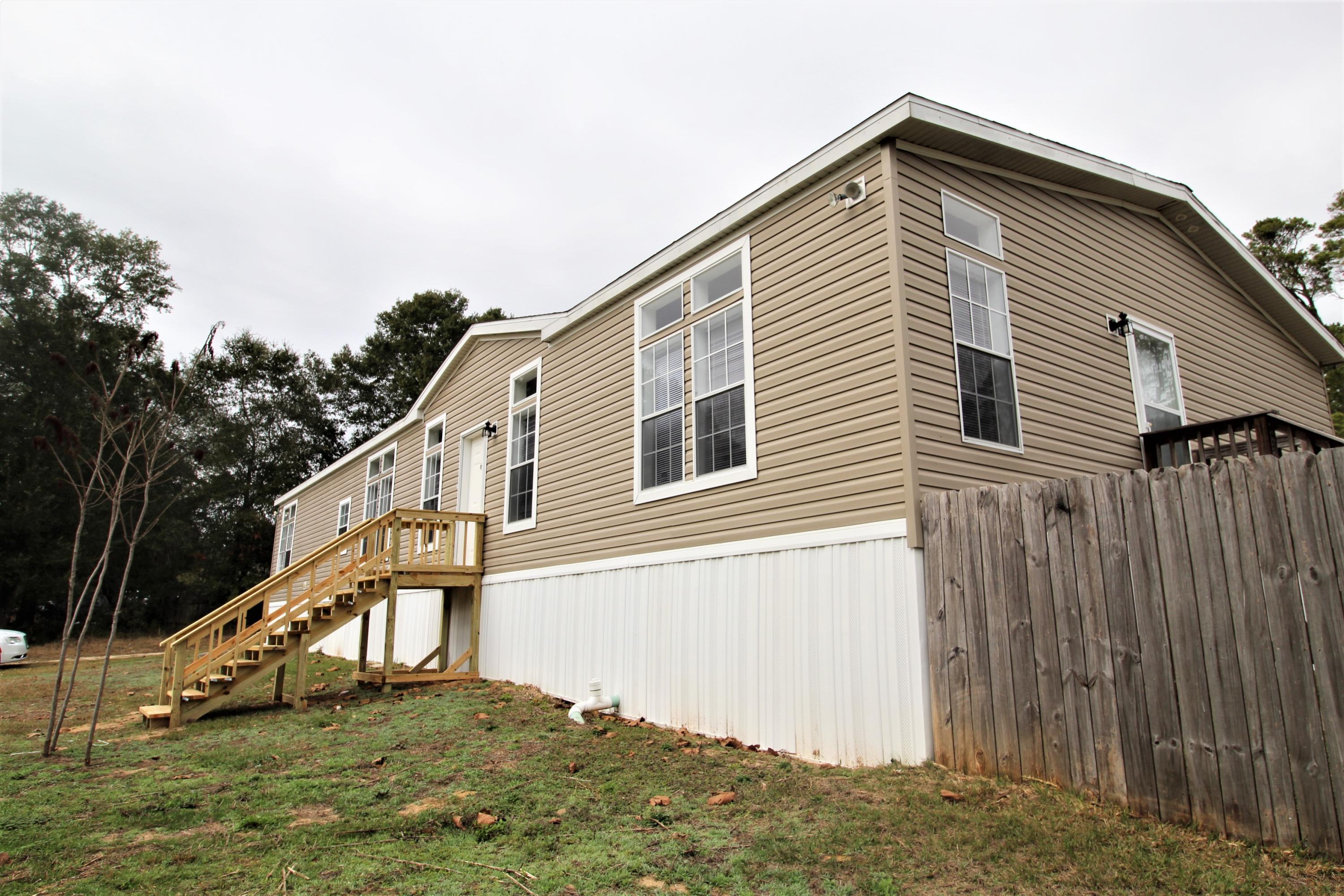 REO, AS-IS. This gorgeous updated home has 2 MASTER SUITES! Loads of extras including Transom windows, crown molding, trey ceilings, sheetrock walls, 2 living areas, 2 covered porches, composite decks, utility sink in laundry, as well as fresh paint, and new carpet. Set on almost an acre (.91), this 2015, 76' x 31', Champion home is a must see. *SELLER FINANCING POSSIBLE *all measurements approximate *MORE PHOTOS COMING SOON