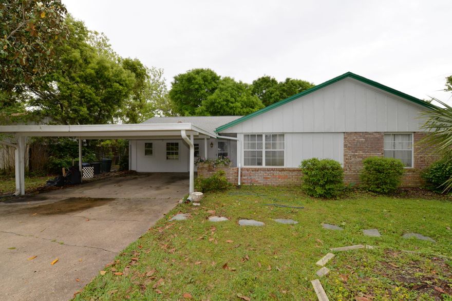 MAJOR INVESTMENT OPPORTUNITY!! Great area for permanent home or investor rental. Walking distance to Destin Elementary & many different churches (close to intersection of Beach & Legion Drive). This three bedroom, two bath home needs updating but is basically a good house. Behind the double carport there is a double garage (garage door is still there). It, meaning the garage, can also be used as a workshop  it has not been finished off as part of the house & is not included in the square footage. There is a patio overlooking a big treed fenced back yard. Excellent potential  a must to see! All information deemed reliable but not guaranteed - sold ''As Is'' with right to inspect.