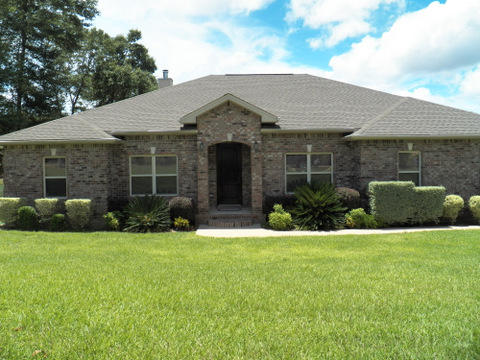 CUSTOM BUILT HOME ON BEAUTIFUL PRIVATE LAKE. This home gives you the feel of living in the country but is just minutes from town center. Kitchen, Bathroom and Utility/Laundry room have travertine floors. Kitchen has granite counter tops with a large walk in pantry. Master bedroom is very spacious with access to the large covered porch. Master bathroom has a large walk in closet, water closet for privacy, whirlpool tub, separate shower with facing His and Hers shower heads. All bedrooms are carpeted with wood flooring throughout the remaining living spaces. Raised ceilings throughout the entire home with trayed ceilings in Master Bedroom, Living Room and Dining Room. Wide crown molding in every room. You will love spending time in the living room relaxing next to the wood burning fireplace