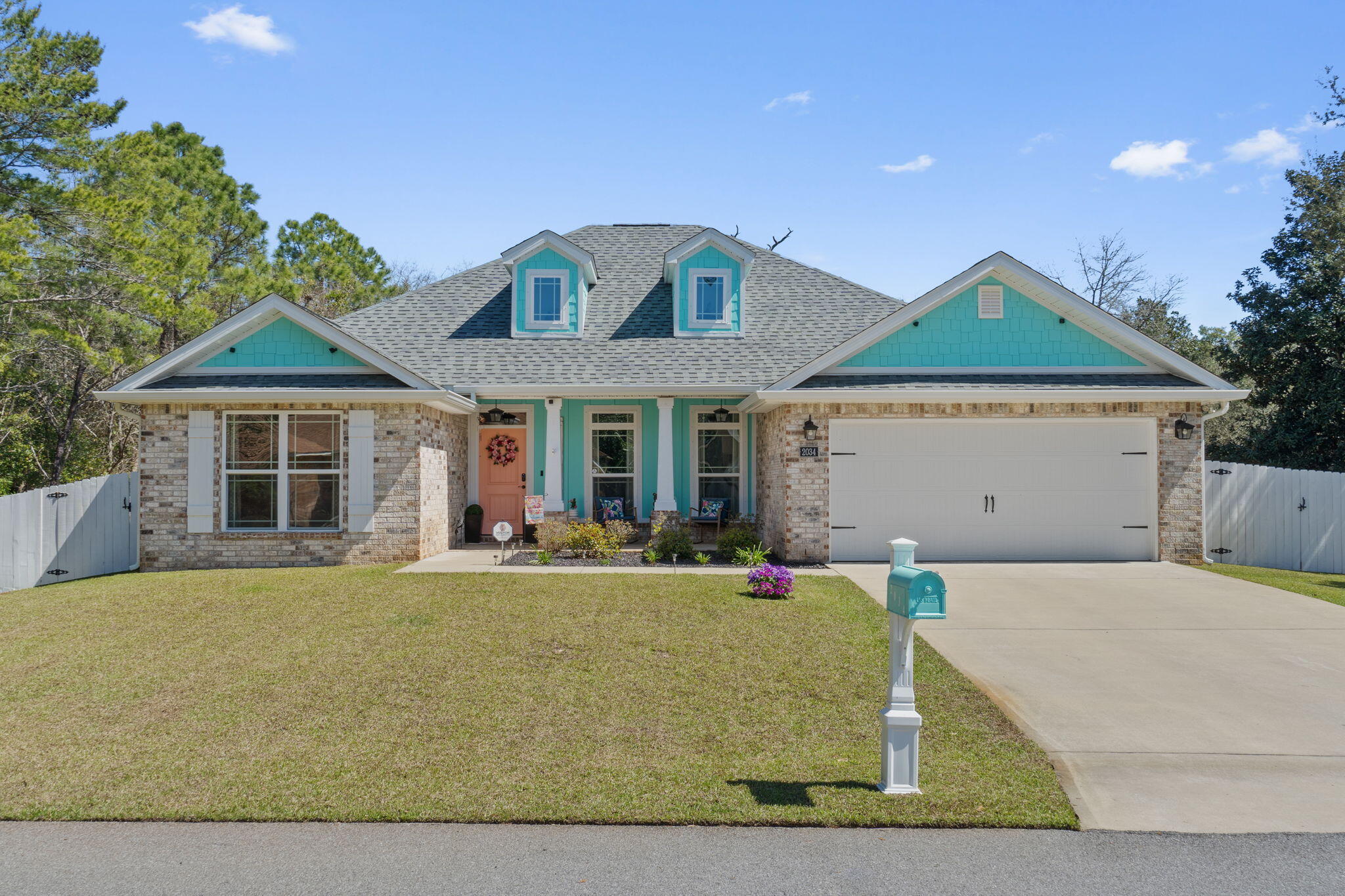 Welcome to this immaculate and better than new east Navarre 4 bedroom, 2 bath 2,091sqft craftsman style home nestled on a half acre lot just 10 minutes to Hurlburt Field! With a serene creek flowing over the back corner of the property, peek a boo views of the Sound, and neighborhood deeded access to the Santa Rosa Sound (but no HOA!) you're going to fall in love with this one owner retreat built in 2021. This Flynn Built designer series Melbourne floor plan is sure to delight with its inviting open design, perfect for creating lasting memories with family and friends. Pull into the driveway and immediately be enchanted by the lovely curb appeal and the coastal colors of the exterior as well as the relaxing covered front porch welcoming you home. Inside you'll love the newly installed cortec flooring, upgraded lighting throughout the home, and the custom touches like archways, trey ceilings, and being prewired for a home theater. The kitchen is a true chef's delight featuring granite counters, a large island with a convenient bar, and stunning cabinets with dovetail soft-close drawers and cabinet doors, as well as the large farmhouse style apron front stainless steel sink. The stainless steel appliances and upgraded lighting add a touch of modern elegance that you're sure to appreciate. There is an eat in kitchen area overlooking the huge backyard, but there's also a formal dining room for you to utilize or use as a flex space! Relax and unwind in the spacious living room, where a tray ceiling adds a touch of sophistication. The master bedroom is truly impressive, with its boxed ceiling and a generous walk-in bathroom closet which has a door that leads straight into the laundry room! Prepare to pamper yourself in the master bathroom, complete with a double vanity, lovely cortec flooring, a gorgeous walk in tiled shower with two shower heads (including a rain head!) and accent tile inlay, and a luxurious garden tub. The other three bedrooms on the other side of the home share a well appointed full sized bathroom, and one thing you will absolutely appreciate in this home is all the closet space! There is a spacious two car garage, providing ample room for your vehicles and storage needs. Step outside and enjoy the fresh air on the covered patio or relax on the beautiful covered front porch, perfect for enjoying a morning coffee or evening breeze coming off the Sound. Welcome home! Have peace of mind with all your major systems only a few years old, the builder's 10 year structural warranty still in effect, and a preventative termite bond in place.
