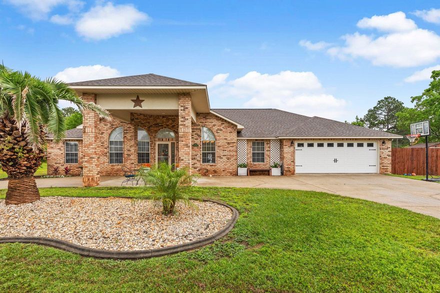 This beautifully crafted brick home is located in the highly sought after neighborhood ''Adrian Woods'' in Milton, FL. Right as you drive up to the home you will notice the beautiful Florida landscaping and convenient circle drive with a portico covering the front door. This home boasts over 2,252 sq. ft. with 4 spacious bedrooms and 2 bathrooms. The entire home has low maintenance ceramic tile flooring. The living space has tall vaulted ceilings, built-in entertainment center and has a great amount of natural lighting making the space very open. It has a shiplapped fireplace with a modern electric fireplace and is open to the kitchen and formal dining areas. The kitchen has all new Samsung dark stainless steel appliances and a large walk-in pantry with new shelving. Continue for more... There is a formal dining room, eat-in kitchen area, and extra barstool space at the counter for optimal seating and space for guests. Located off of the living room is a long hallway that has the entrances to 3 sizable bedrooms and a bathroom. Right off the kitchen is the master bedroom. Here you will find 2 spacious walk-in closets with new shelving and an attached master bath with a walk-in shower and separate garden tub and new double vanity. The patio has an entrance from the master bedroom along with 2 additional entrances from the home making for easy access to the lovely outdoor space. You will want to spend all your time in this backyard. A new fence was installed in 2020 and there is a 12'X16' shed with a 2020 roof that is great for extra storage. New paver pad inside the fence perfect for your boat or RV.  New 12x12 deck is a great space for grilling and/or hanging while kids play. The pond view and large yard make it the perfect place to relax and entertain. The laundry room also has new shelving and a new utility sink. Roof is 2020. Water Heater is 2020. HVAC system is 2021. The Adrian Woods HOA allows access to fishing in all three of the neighborhoods ponds. This home has so much to offer, call before its gone!