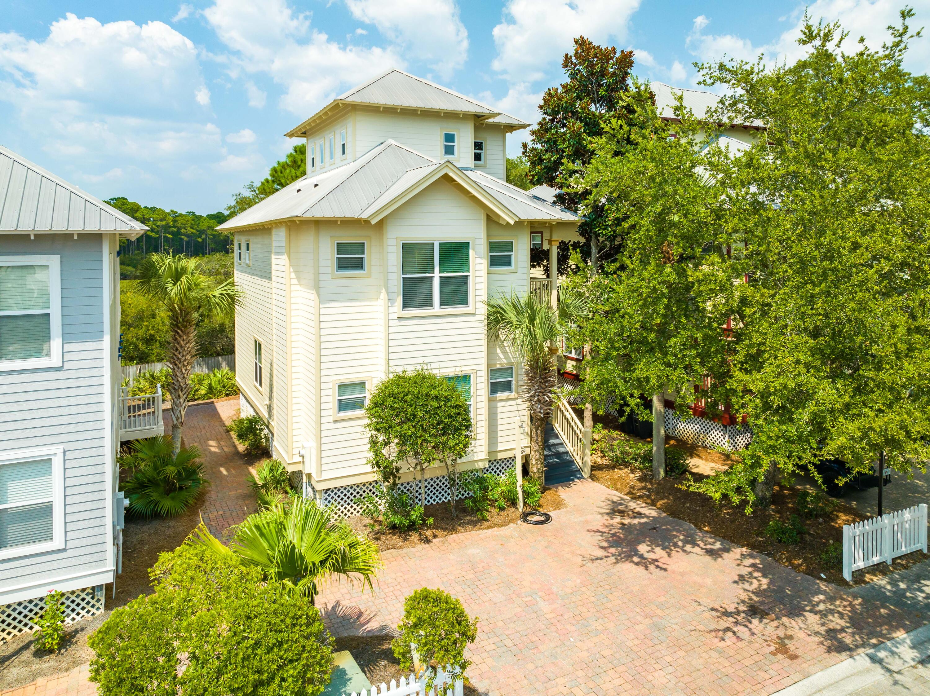 ''30 Play'' in the gated beach community of Old Florida Village, offers a spacious 2016 SF floor plan with 3 bedrooms and 3 full baths. The home lives like a 4 bedroom home with the 3rd floor tower which allows plenty of room for additional guests. The home's close proximity to the front of the neighborhood will make this a popular vacation rental, as you have easy access to one of the 2 community pools right across the street, as well as 3 public beach access points less than a 3 minute bike ride away. The quaint scrub oak bordered streets, with white picket fences and community walking trails, make Old Florida Village a family favorite in Blue Mtn Beach! The main living areas of the home are located on the first floor as well as a bedroom and full bath. The covered back porch with bbq