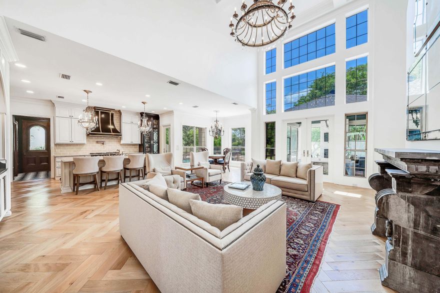 Simply stunning! This home has been completely remodeled, down to the studs, including walls moved and adding square footage, all custom with exquisite details. Gorgeous new white oak hardwood floors in a beautiful herringbone pattern, new kitchen, all new bedrooms and baths, new screened in outdoor living space, newly redone pool and outdoor patio, new fixtures, almost everything is brand new, inside and out! This is the home you have been waiting for with 5 bedrooms, 4 and a half baths, 2 kitchens, incredible screened in outdoor living room with fireplace, beautiful pool with spacious travertine patio, oversized lot with lovely large backyard, circular drive, and 3 car garage. This home features 5 fireplaces, including
