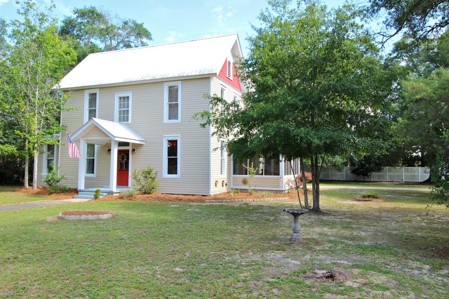 Character in every possible way. Located in the historic district just 1 block from Lake DeFuniak on a corner lot. Exceptional condition! The heart pine floors literally gleam. Open to the living room, the kitchen with inset, shaker style cabinets showcases a copper hood & stain glass windows. One bedroom + bath downstairs with 3 bedrooms and a bath upstairs. Cool under stair storage with many possibilities! You'll also find TWO sizable landing areas (one plenty large for office or playroom) and the coolest split staircase you may ever find. Original features include doors & doorknobs, tall windows w/ original glass and high ceilings. A screened porch is just off the kitchen for convenience and family gatherings. Small detached garage and storage building give you the extra space you need