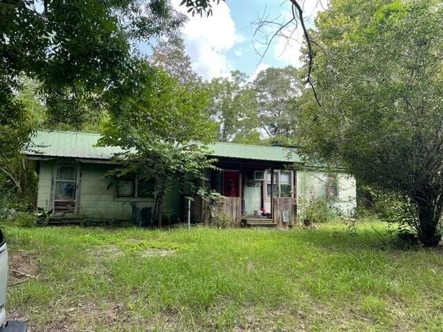 Half acre, level lot located in the heart of Laurel Hill and close to Laurel Hill High School. Property is zoned commercial and residential. This property has road frontage on HWY 85 and access from 4th St. Building is uninhabitable/tear down or fixer upper. Please use caution and enter at your own risk.Buyer to verify all measurements and pertinent information.
