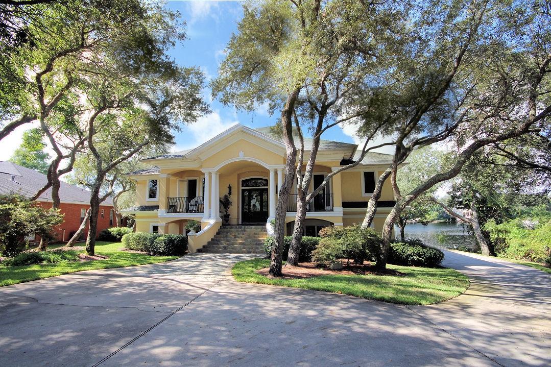 Waterfront living at its finest! One of the largest lots and 220 feet on Lake Lorraine with direct bay access. Be at Crab Island or Destin Pass in 5 minutes. No detail has been overlooked in this incredible home on large wooded lot. Gourmet eat in Kitchen and Formal Dining all with great water views. Three full bedrooms and bathrooms with additional study and fitness room plus huge entertainment room with built in wet bar and just steps to your sparkling pool. French doors lead to large sweeping balcony and covered patio, all overlooking your private dock with 42ft boat slip, 24ft boat lift and jet ski lift and large deck. High efficiency home with the highest quality construction inside and out. Additional golf cart garage, safe room and two HVAC units for comfort upstairs and do