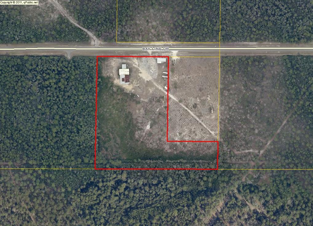 10 acre parcel zoned commercial/industrial located in close proximity to several county establishments. Small office on site, several large covered structures for commercial equipment or machinery.