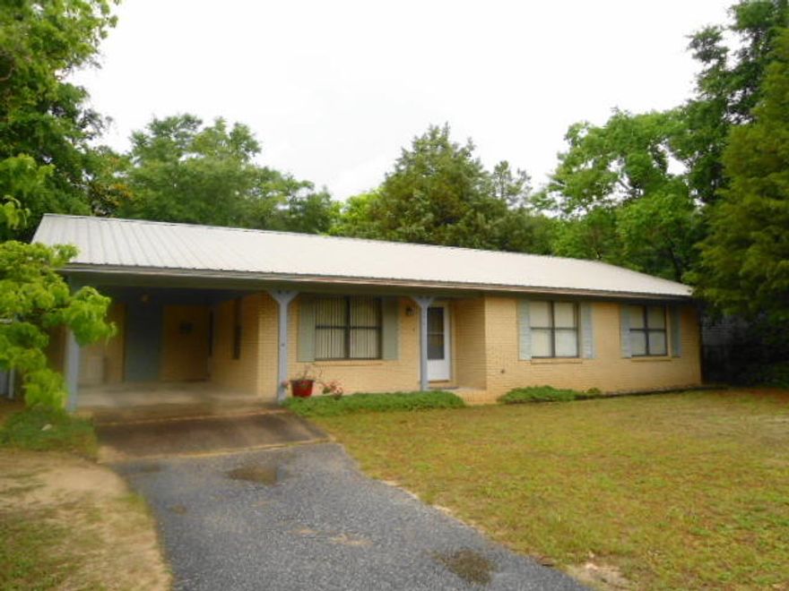 Need help with closing costs? This Seller will pay up to 6% of the sales price towards Buyer's closing and lenders costs...you payout very little....so why wait, 100% financing is available if you qualify... perfect location and home, brick, metal roof and well cared for and near schools and stores. Home has been updated with new hand scraped laminate wood planks flooring in great room. Space saver kitchen with lots of cabinets and breakfast bar. Sliding glass doors from dining room area to screened in back porch and covered patio. Master bedroom has walk-in shower, hall bath with full tub. Each bedroom will accommodate most furniture. Back yard is fenced and has 2 storage buildings. This is the perfect starter size home or home to down-size. Call today, easy to show.