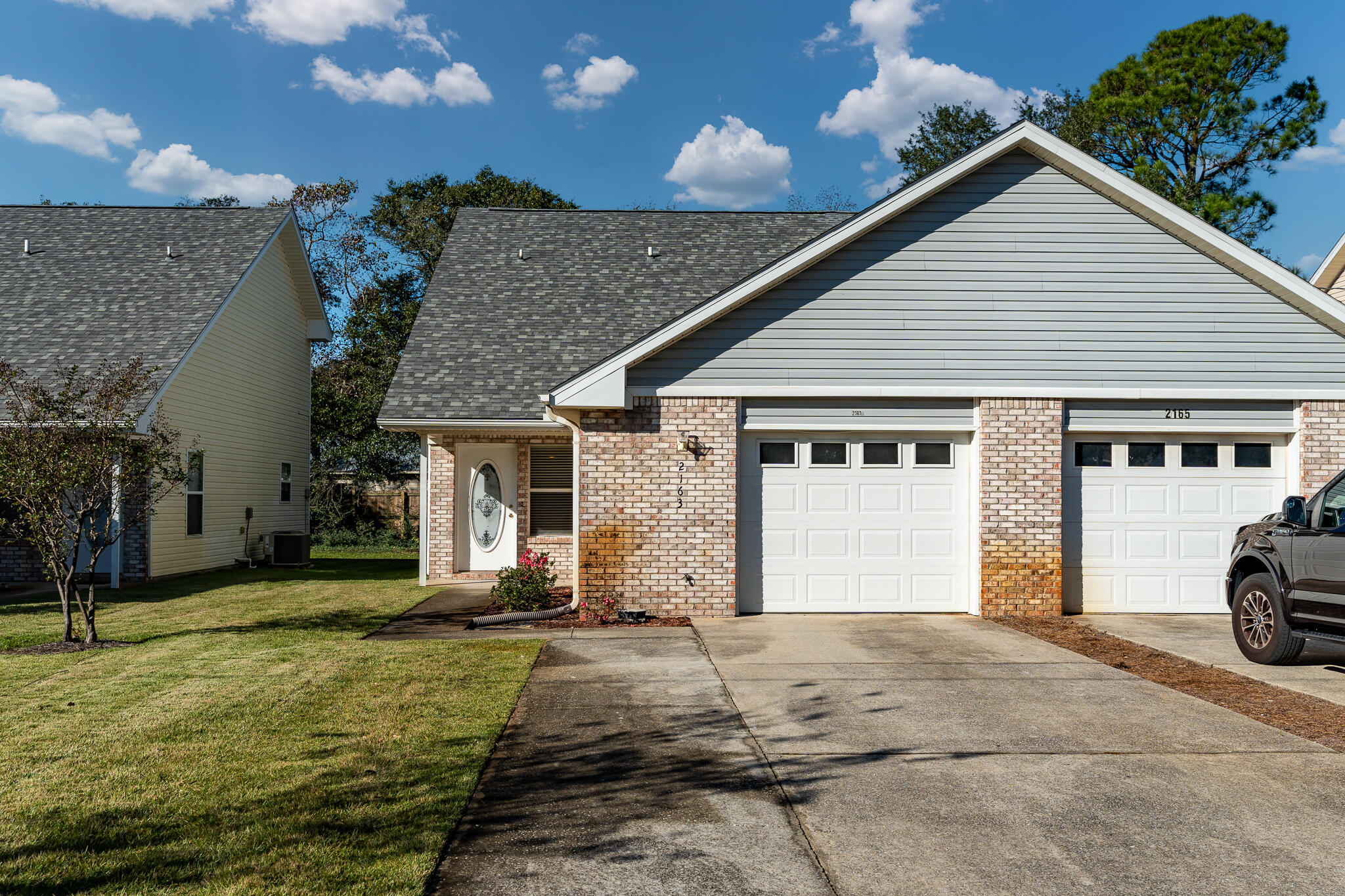 Discover one of the most affordable homes in East Navarre, ideally located just 8 miles from Hurlburt Field and minutes from the pristine white sands of Navarre Beach. This charming residence features an open-concept living area, perfect for modern living. The bright kitchen is equipped with a breakfast bar, pantry, built-in microwave, and electric stove. The spacious primary bedroom, located on the first floor, offers ample space for your furnishings. Upstairs, enjoy the privacy of two generously sized bedrooms accompanied by a full bathroom. The washer and dryer hookups are conveniently located in the garage. Step outside to the back patio, an ideal spot for grilling and enjoying the outdoor space. Notable updates include a new roof installed in 2021 and a water heater from 2012.