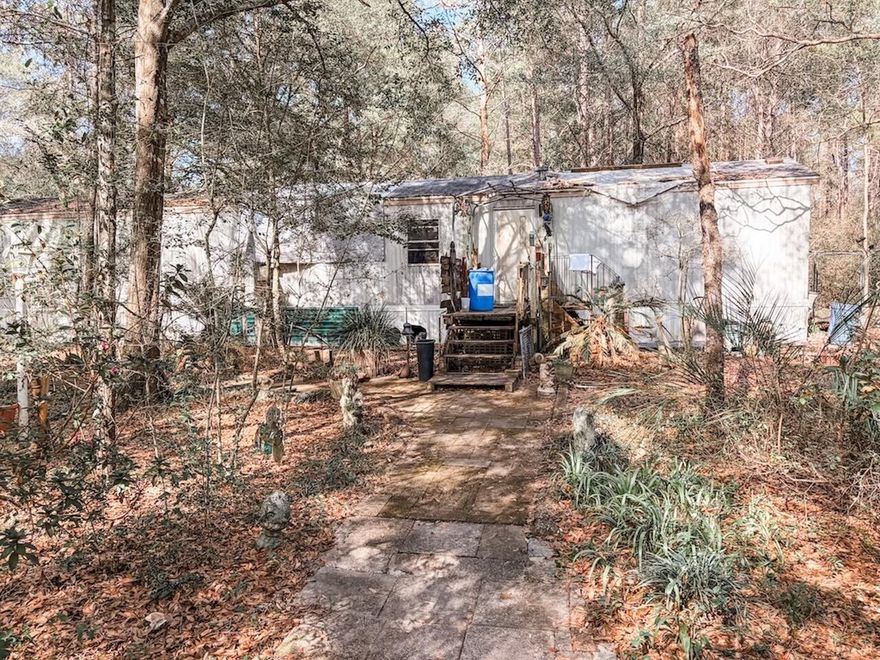 Approximately 6 acres with an existing mobile home built in 1997. Property conveys as-is and is priced primarily for land value. Buyer to verify all information, contact listing agent for all showings.